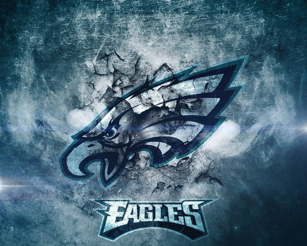 Eagles 桌布 壁紙 — 一個粗糙的費城老鷹標誌從裂開的混凝土牆中浮現，帶有戲劇性的燈光和風化的紋理。