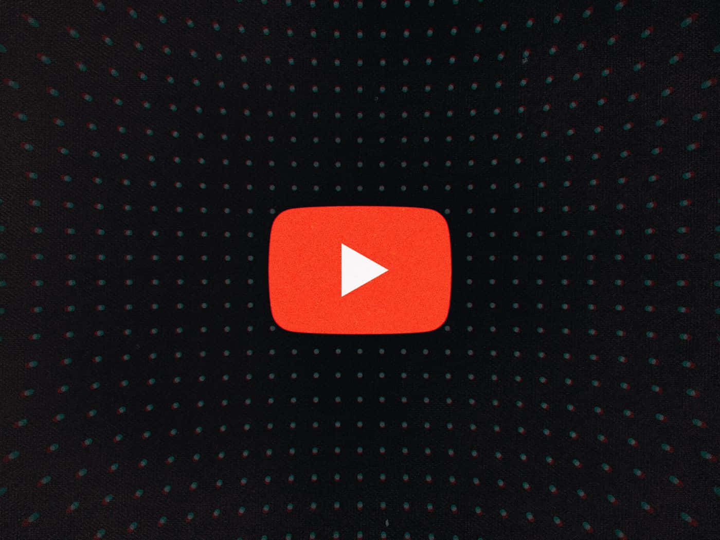 YouTube縮圖 桌布 壁紙 — 一個紅色YouTube播放按鈕居中於深色布料上，帶有散落的青綠色和紅色圓點。