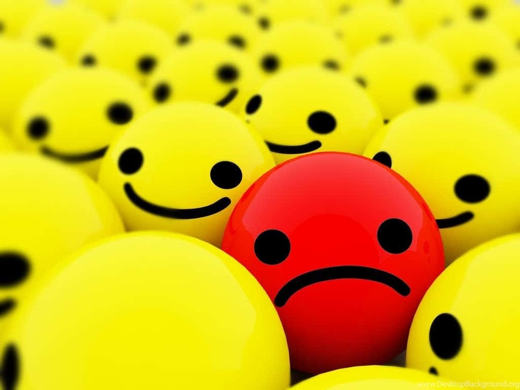 Whatsapp Dp 桌布 壁紙 — 一個紅色悲傷的臉孔在一片黃色笑臉的海洋中，在淺景深下脫穎而出。
