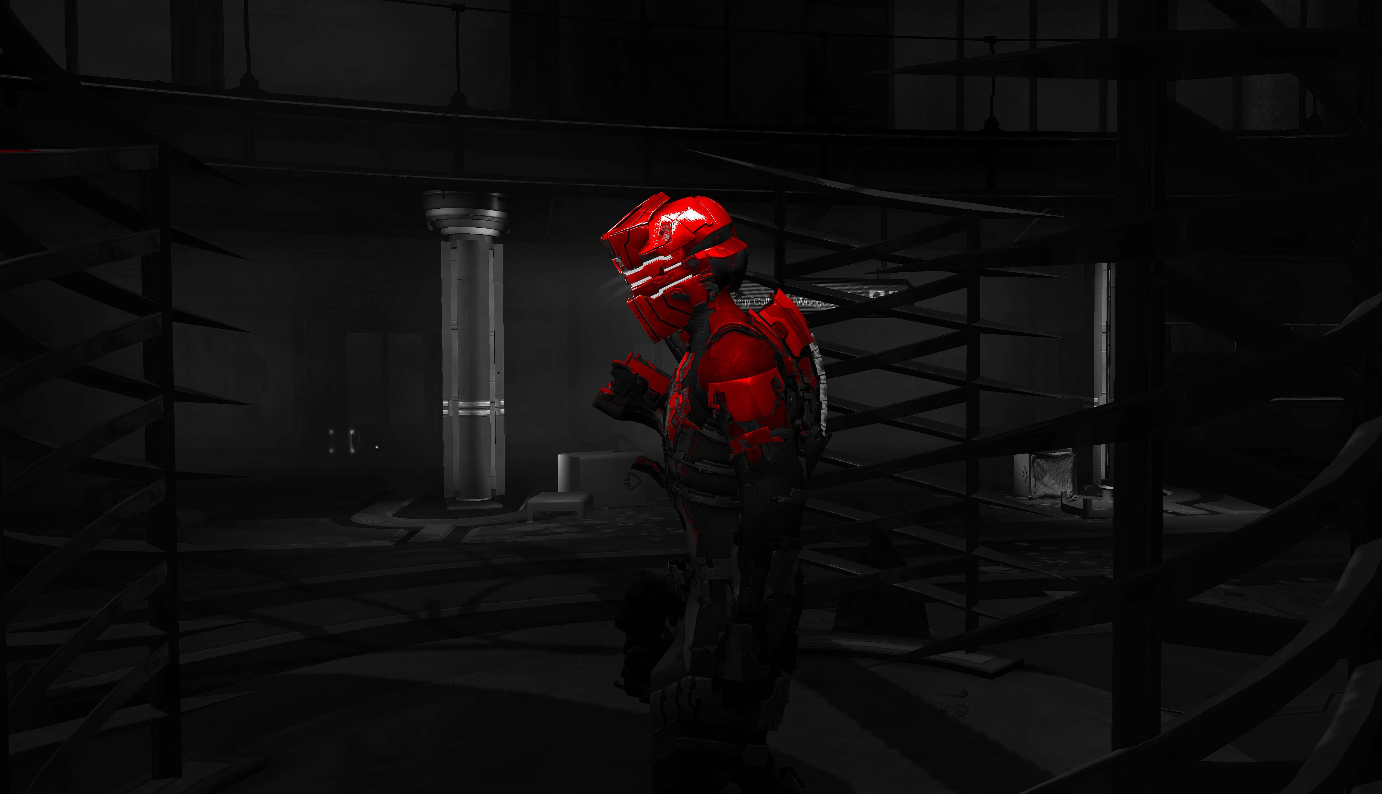 Dead Space 4K 桌布 壁紙 — 一個紅色裝甲人物站在黑暗的工業廢墟中，周圍有骨架般的金屬結構和單色環境。