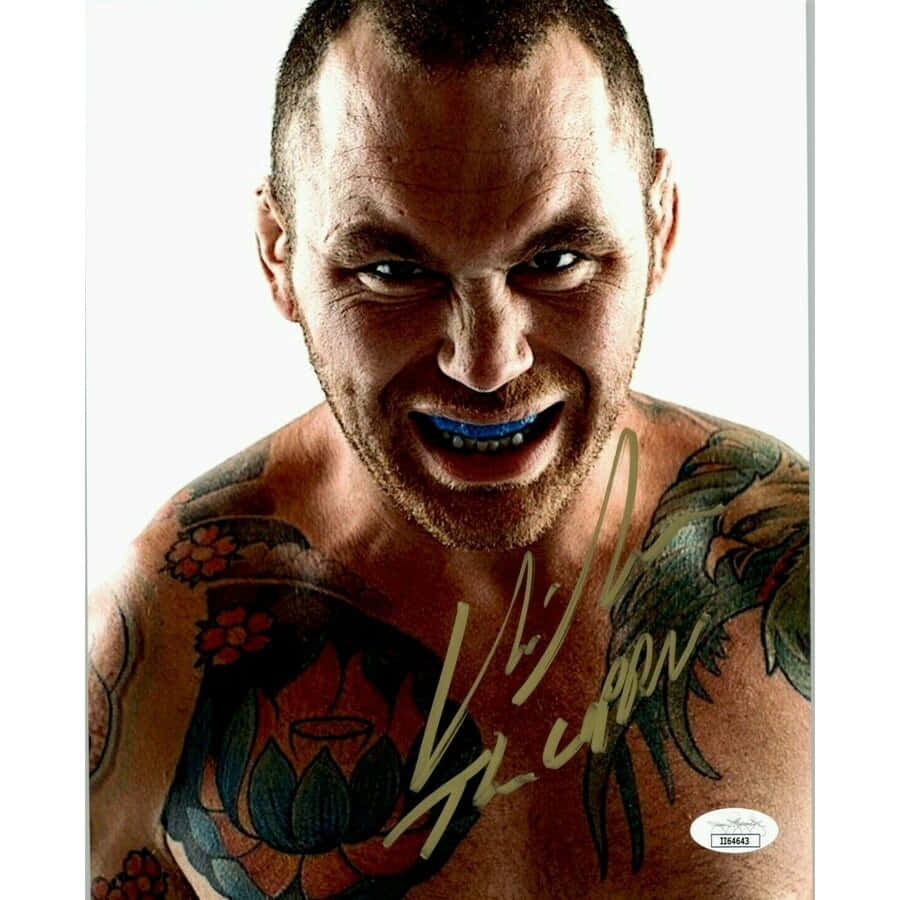 tattoos 桌布 壁紙 — 一個紋身男子戴著藍色護齒，眼神凌厲，在純白背景前的激烈特寫。