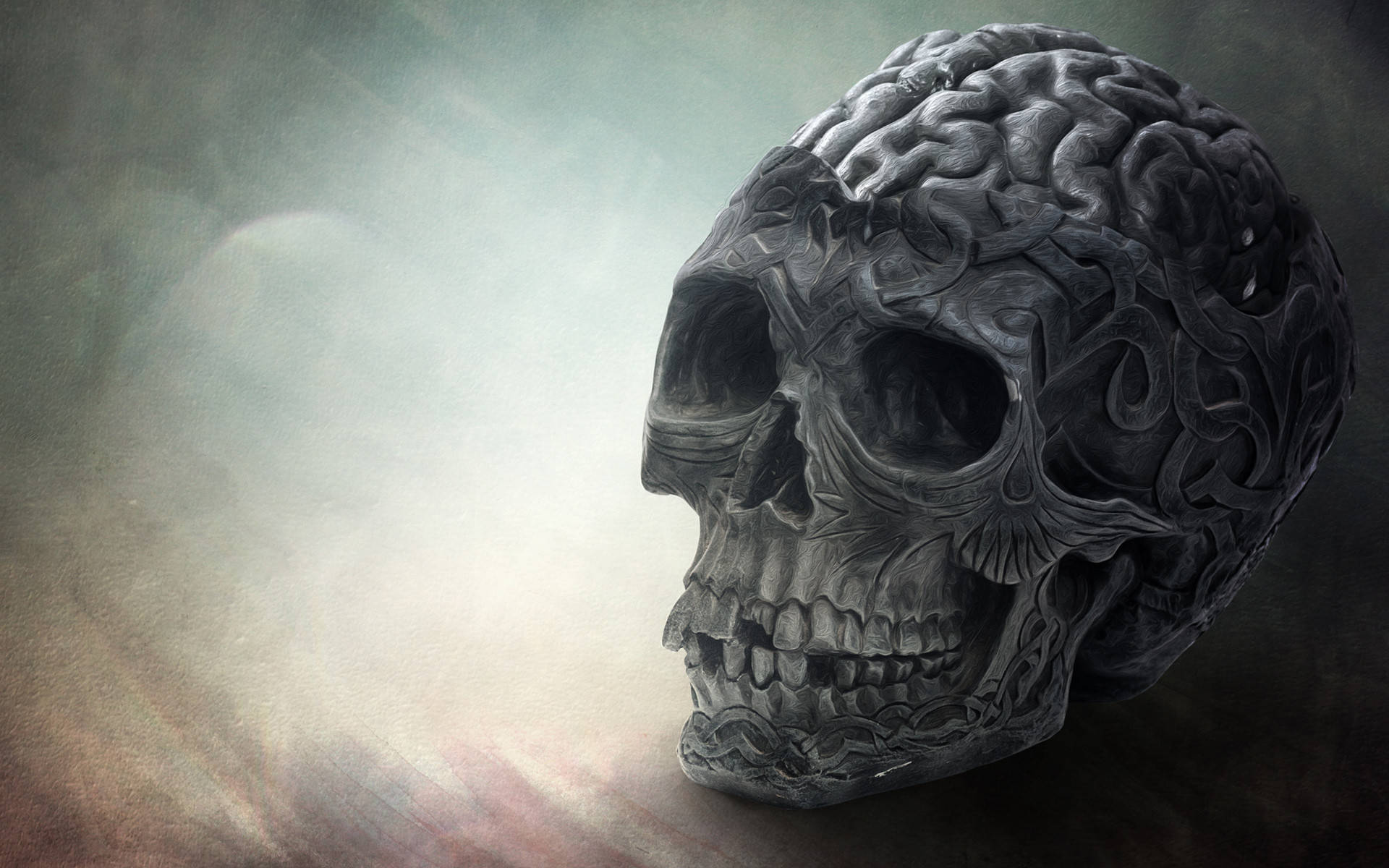 HD Skull 桌布 壁紙 — 一個細節豐富的深色頭骨，帶有大腦般的紋理和漩渦圖案，背景是霧狀漸變。