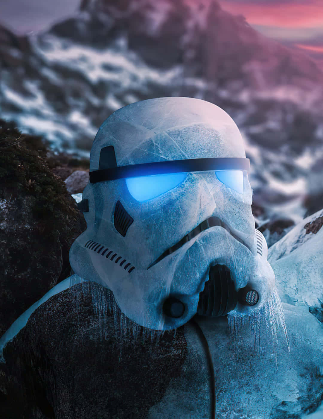 Star Wars Profile 桌布 壁紙 — 一個結霜的風暴兵頭盔，帶有發光的藍色眼睛，在暮色中安放在冰雪覆蓋的岩石上，背景是雪山。