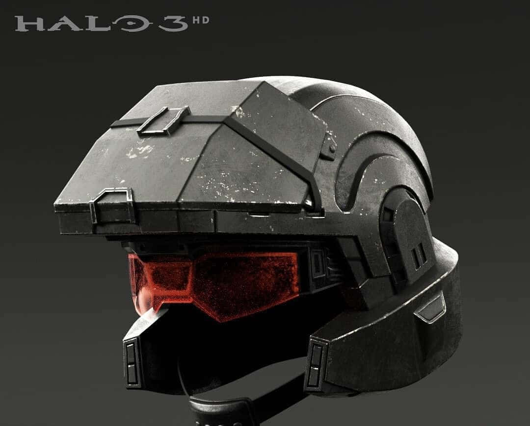 Halo Unsc 桌布 壁紙 — 一個經過風化的黑色Halo 3斯巴達頭盔，帶有發光的紅色面罩，背景為深灰色。