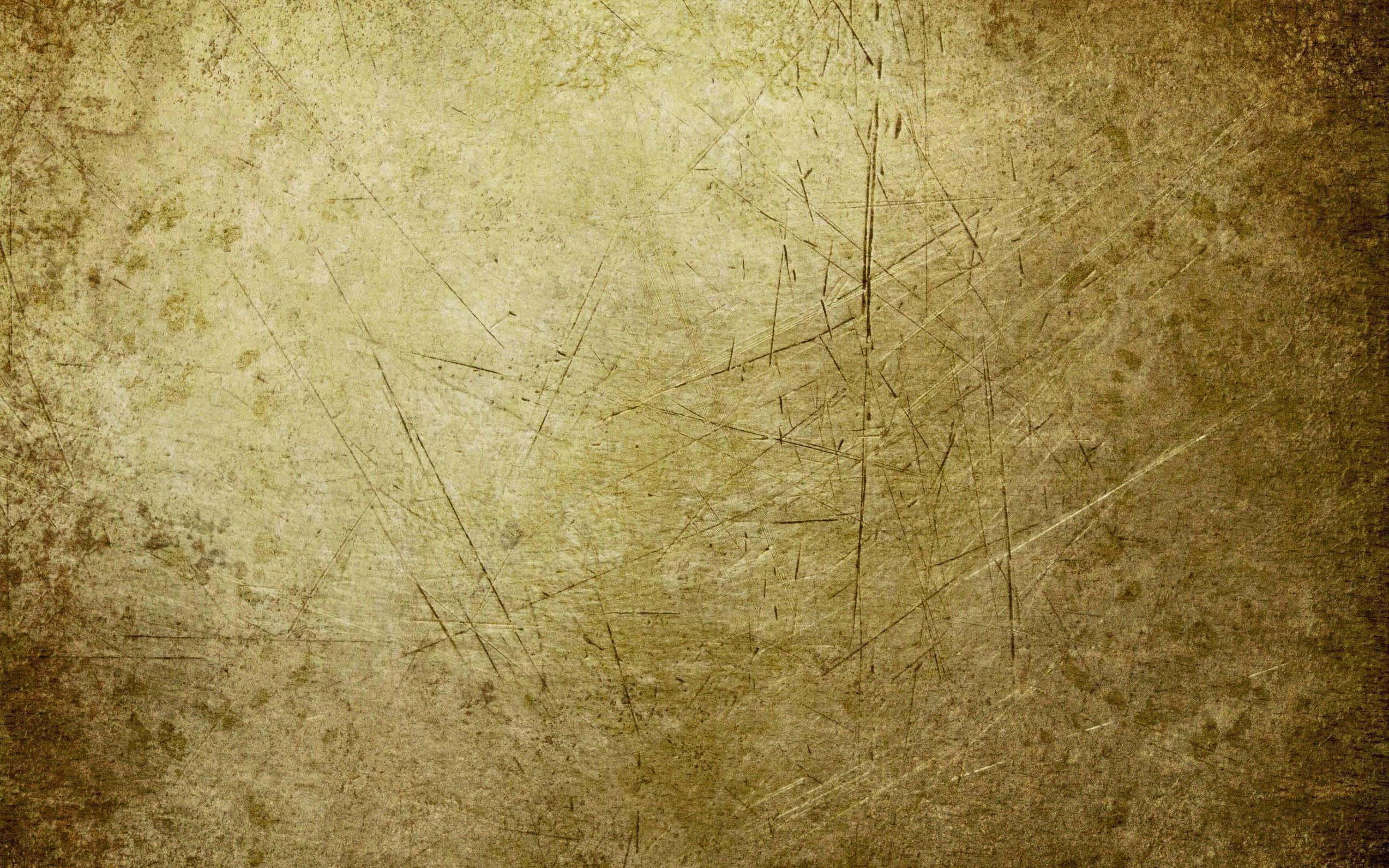 Grunge Texture 桌布 壁紙 — 一個經風化的米色表面，帶有刮痕和污漬，營造出復古紋理背景。