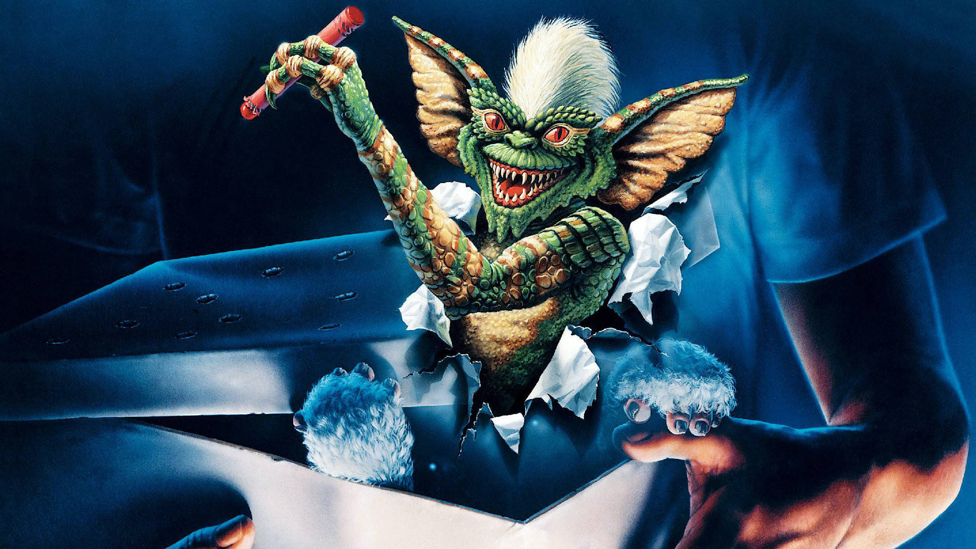 Gremlins 桌布 壁紙 — 一個綠色哥布林，紅眼白髮，從一個破爛的紙箱中衝出，手持一支紅色雪茄和兩隻毛茸茸的藍色生物。