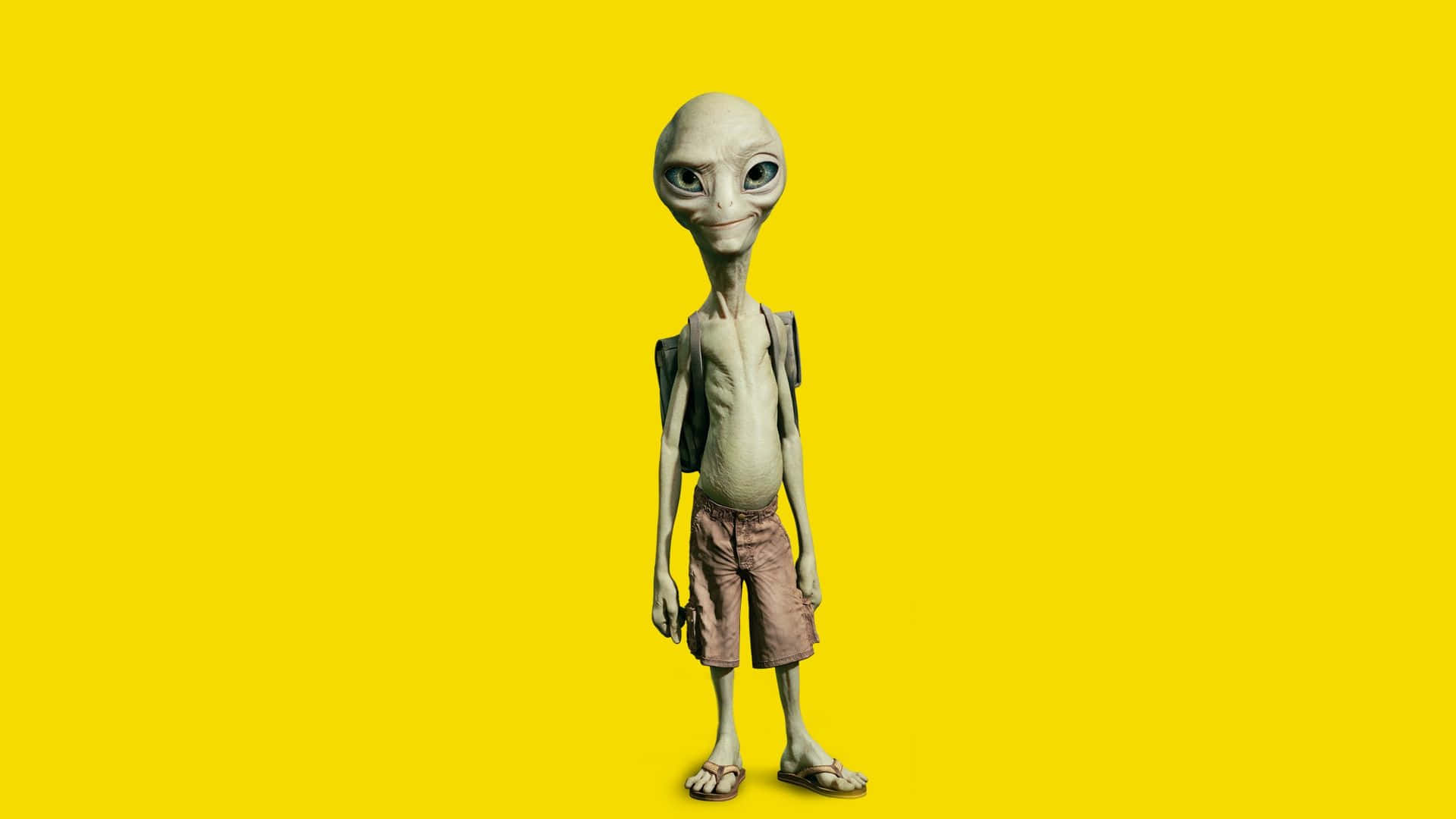 外星人 桌布 壁紙 — 一個纖細的灰色外星人，大眼睛，揹著背包，站在明亮的黃色背景前。