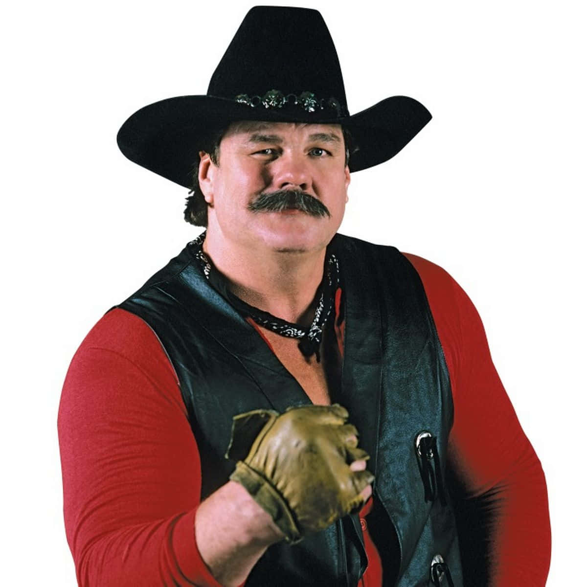 WWE 桌布 壁紙 — 一個肌肉發達、留著濃密鬍子的男人，戴著黑色牛仔帽、紅色襯衫和黑色背心，戴著皮手套向前指。