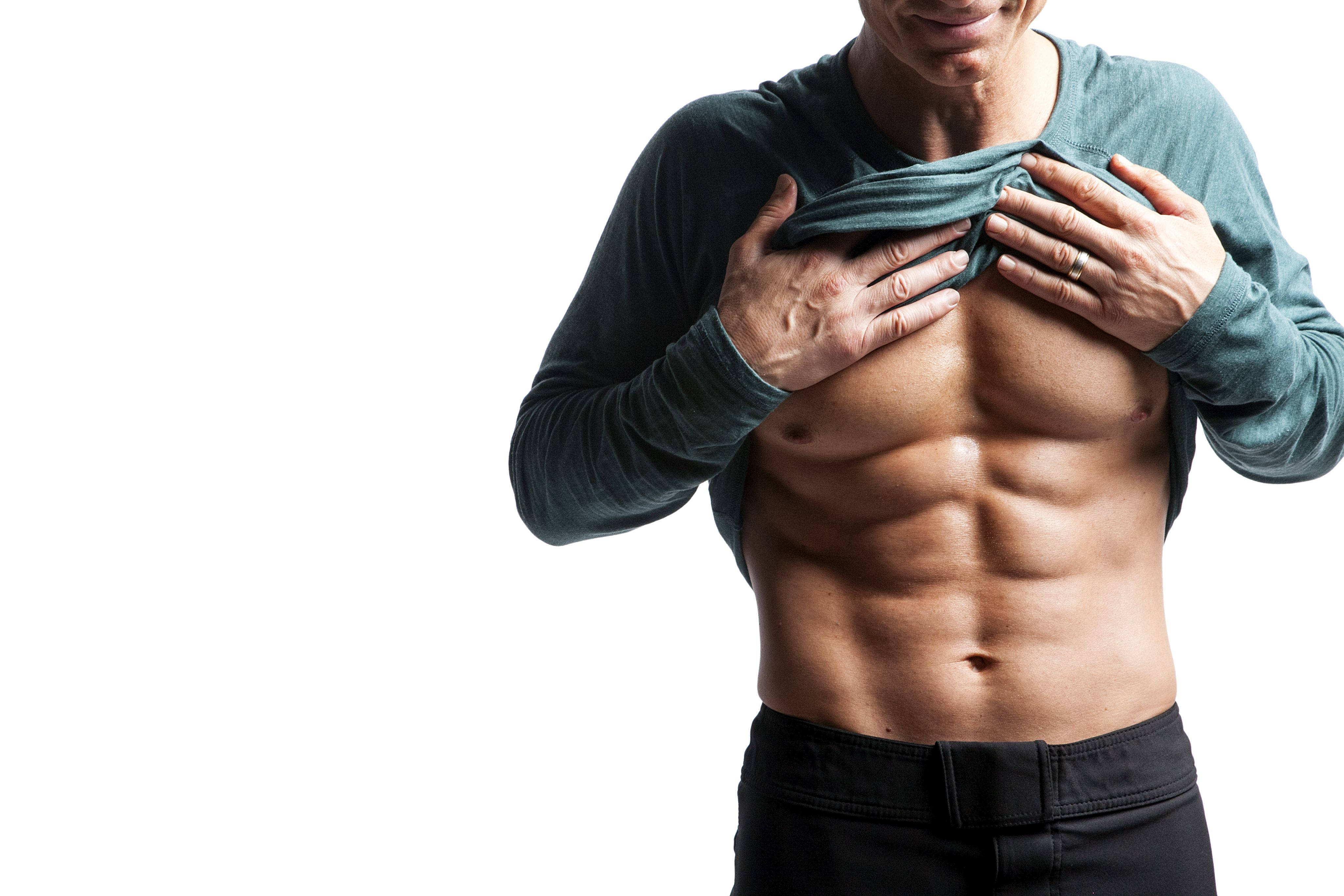 Fitness 桌布 壁紙 — 一個肌肉發達、腹肌分明的男人在純白背景前拉開他的綠色襯衫。