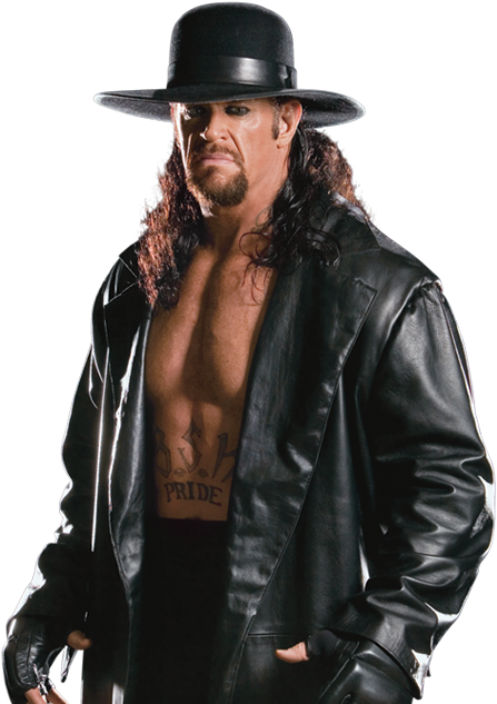 Undertaker 桌布 壁紙 — 一個肌肉發達、長髮及山羊鬍的男人，戴著黑色軟呢帽，穿著敞開的皮夾克，露出胸前的刺青，背景為黑色。