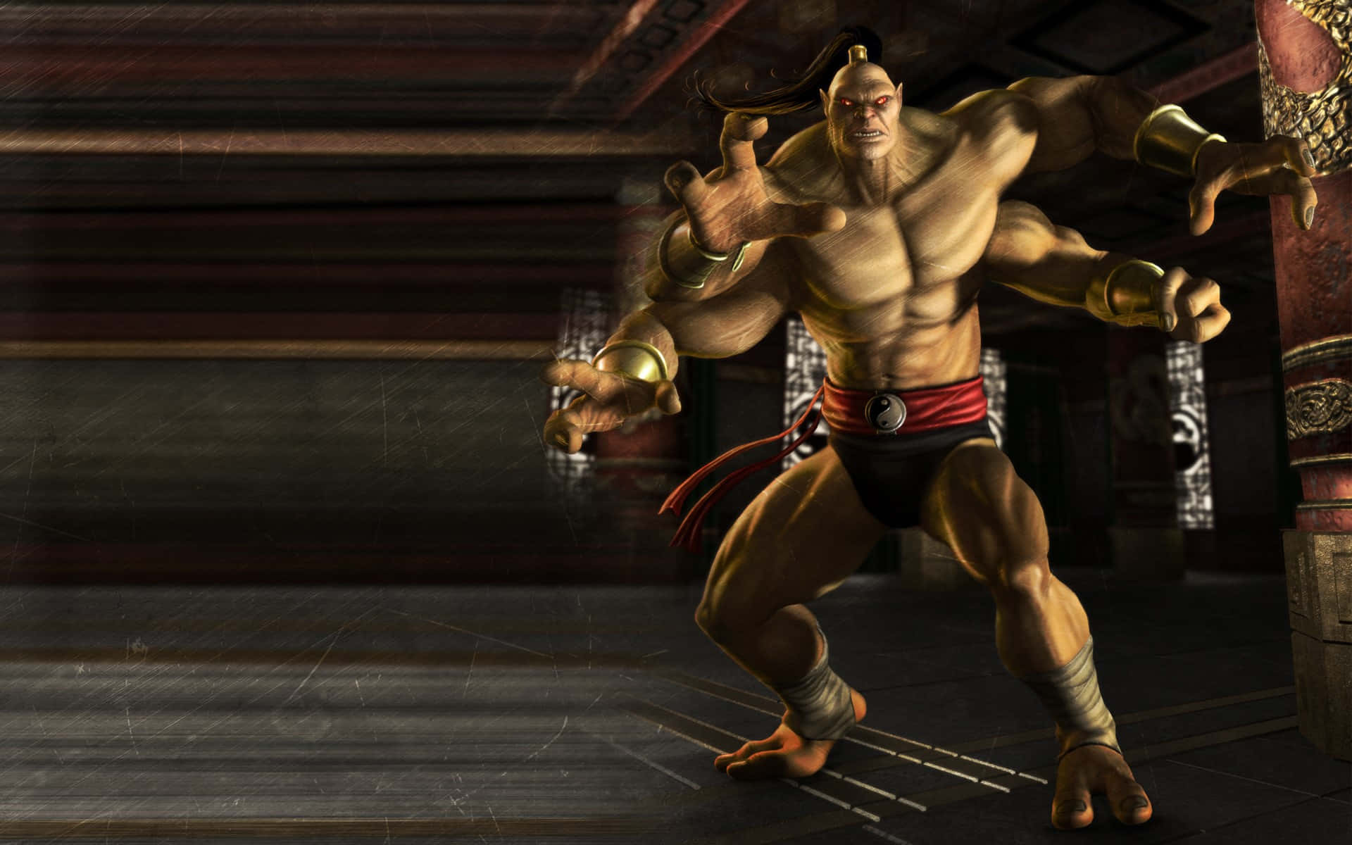 Mortal Kombat Goro 桌布 壁紙 — 一個肌肉發達的動畫戰士，紅眼睛，戴著金色臂環，在光線昏暗的傳統道場中擺出戰鬥姿勢。