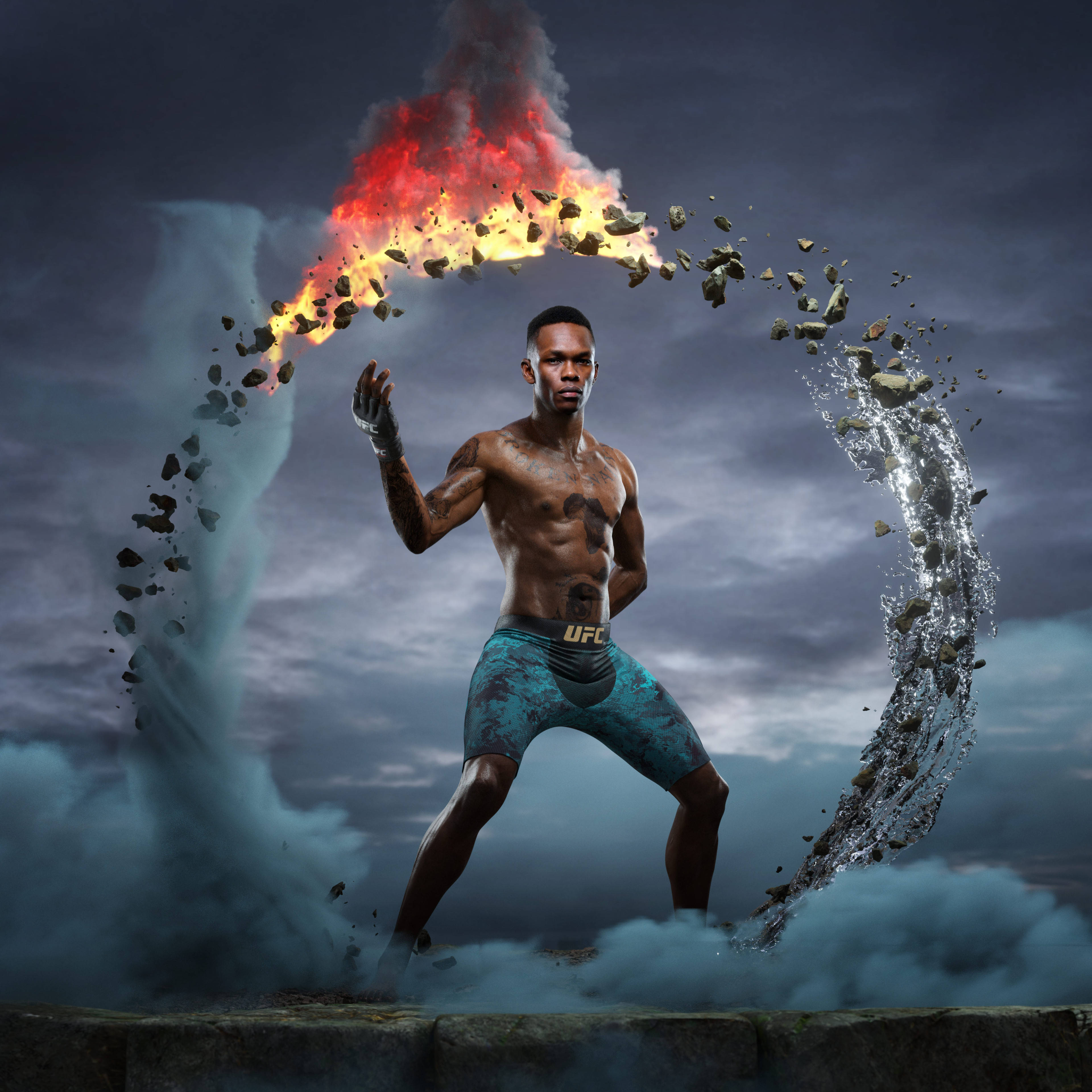 Adesanya 桌布 壁紙 — 一個肌肉發達的戰士擺好姿勢，火與水的元素在他周圍旋轉，形成戲劇性的元素展示。