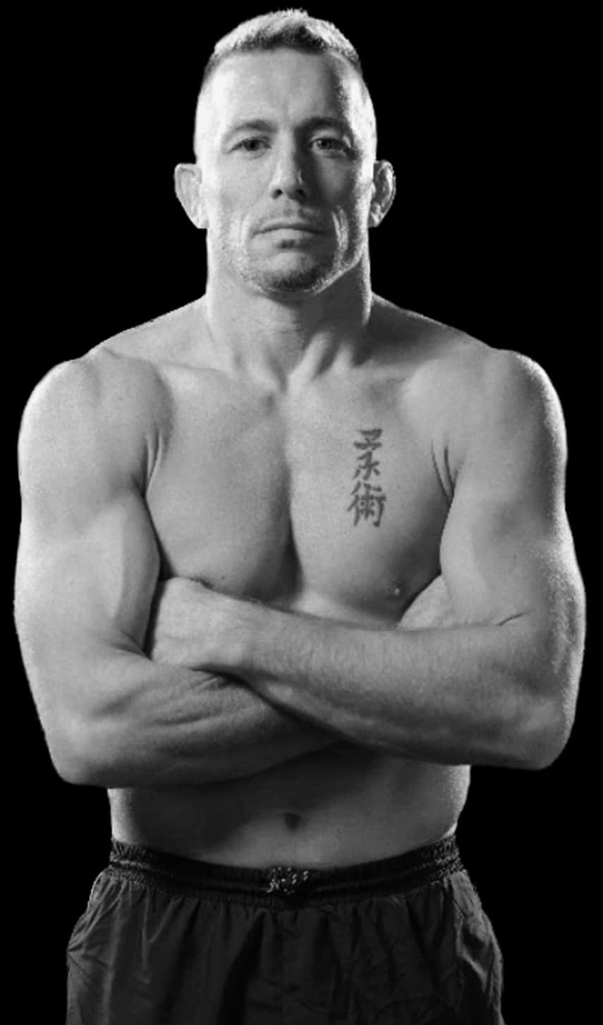 UFC 桌布 壁紙 — 一個肌肉發達的男人交叉雙臂，在黑色背景下凝視，胸前可見垂直紋身。