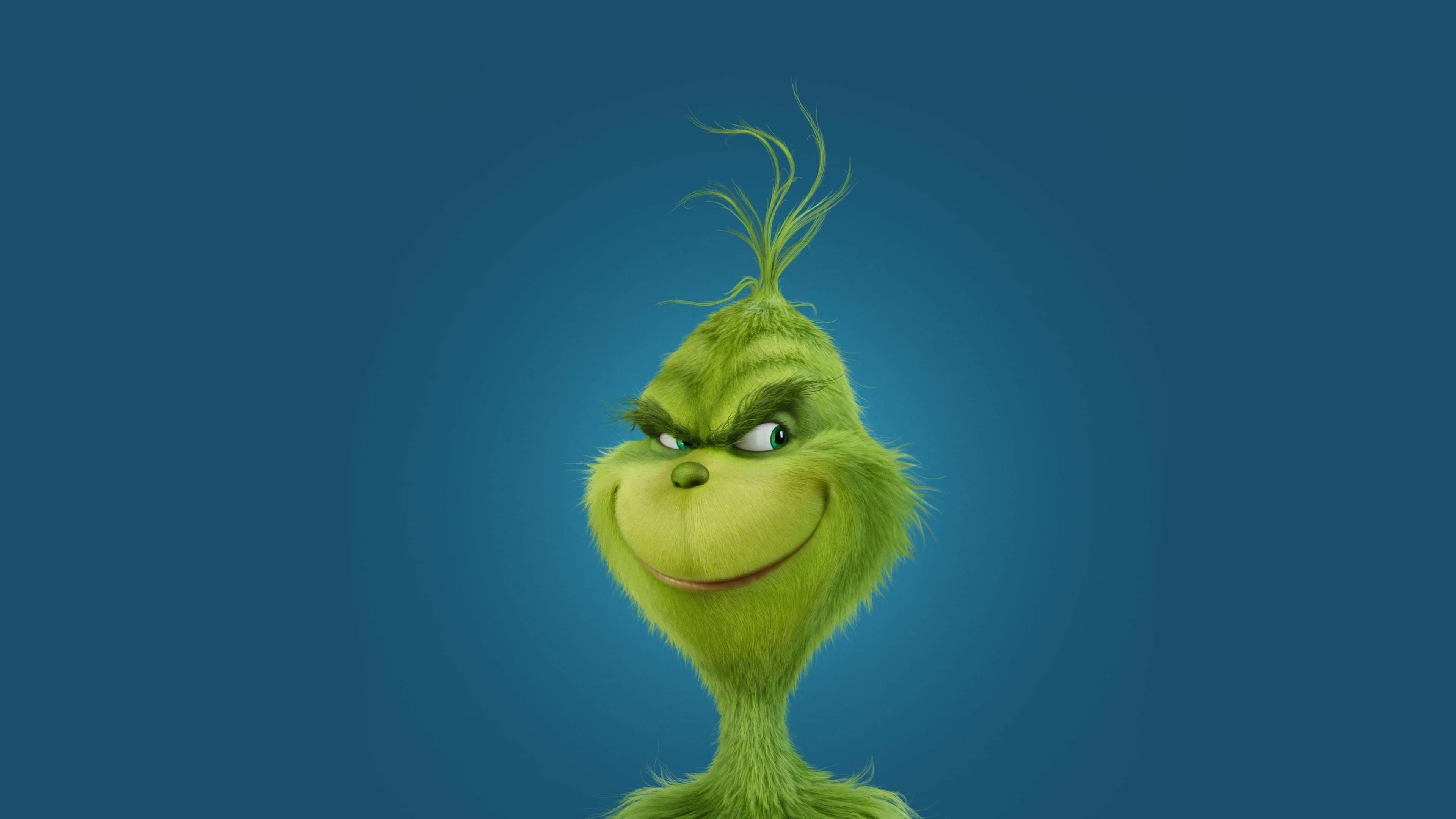Christmas Grinch 桌布 壁紙 — 一個脾氣暴躁的綠色鬼靈精，帶著得意的笑容和尖刺的頭髮，背景是深藍色漸層。