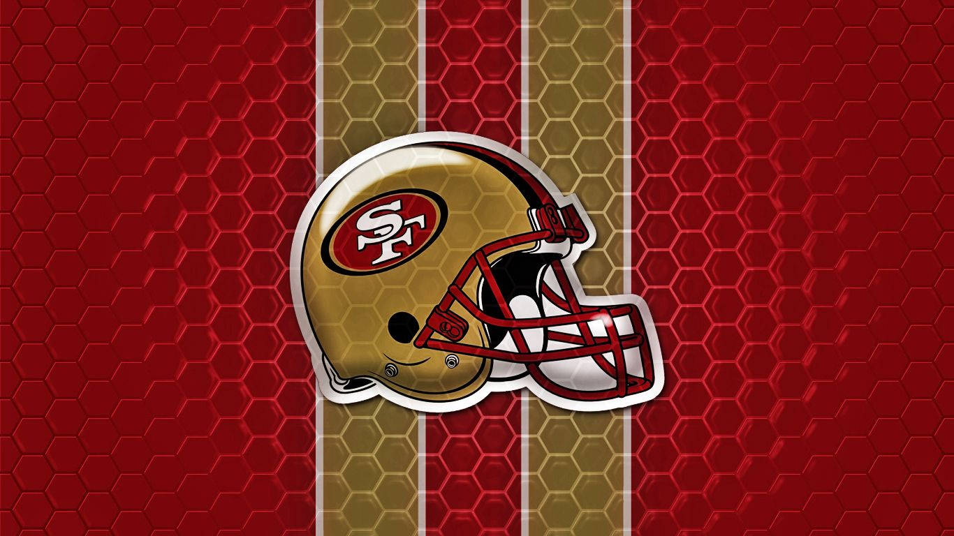 49ers 桌布 壁紙 — 一個舊金山49人隊美式足球頭盔，置於紅金六邊形圖案背景中央。