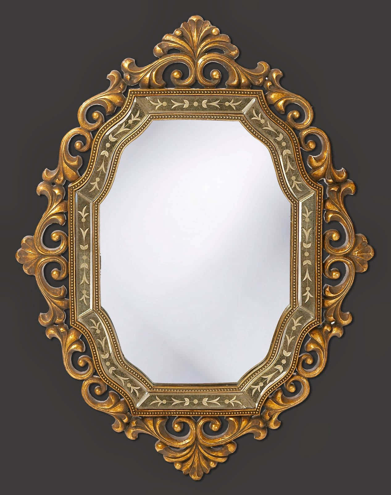 mirror 桌布 壁紙 — 一個華麗的金框鏡子，帶有複雜的旋渦紋和葉子圖案，背景為深灰色。