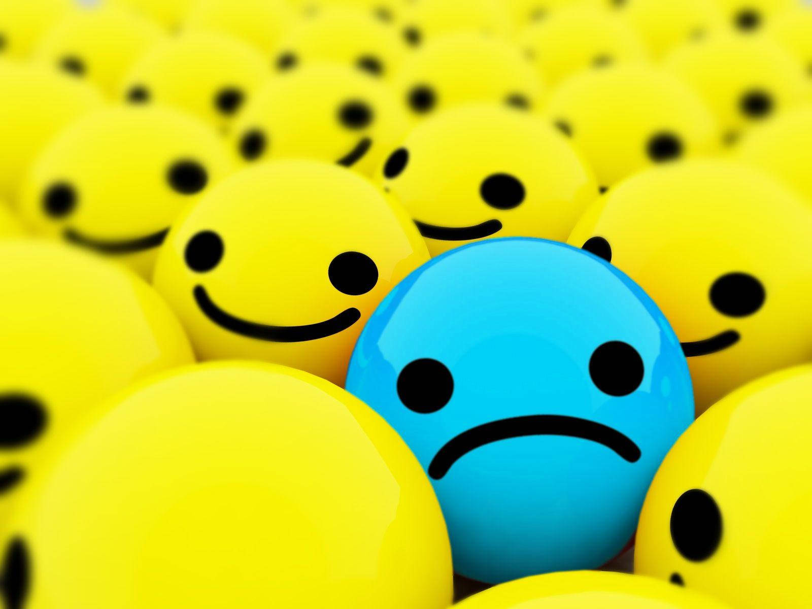笑臉 桌布 壁紙 — 一個藍色悲傷表情符號在一片黃色微笑表情符號中脫穎而出，景深較淺。