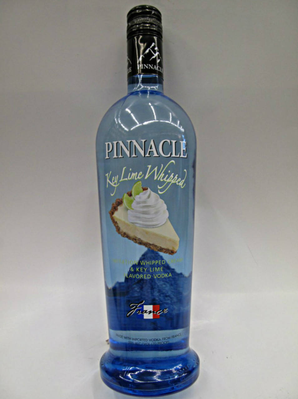 bottle 桌布 壁紙 — 一個藍色玻璃瓶的 Pinnacle Key Lime Whipped 伏特加，標籤上有鮮奶油和萊姆裝飾。