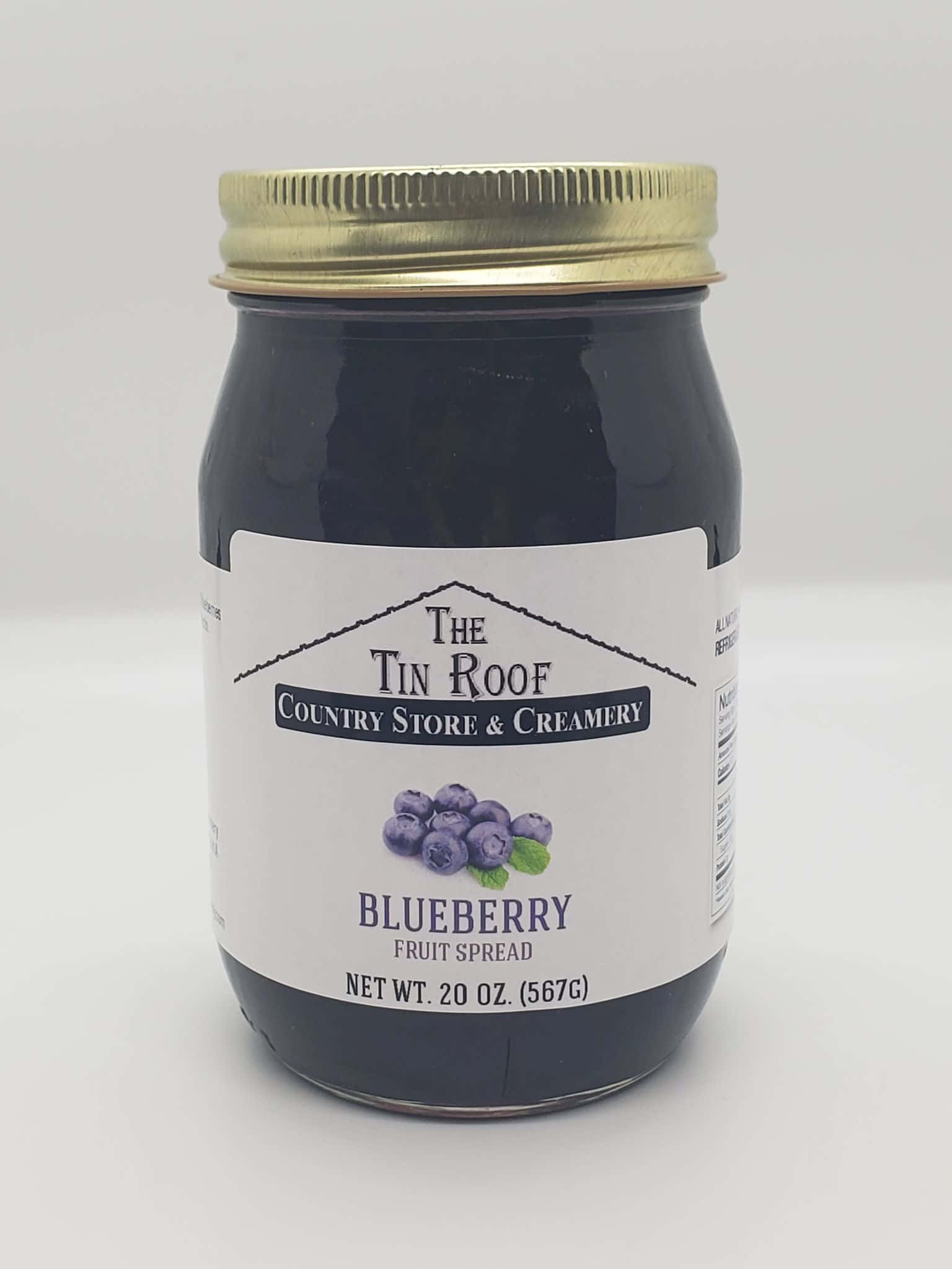 Blueberry Jam 桌布 壁紙 — 一個藍莓果醬玻璃罐，帶金色蓋子和白色標籤，居中放置在純白色背景上。