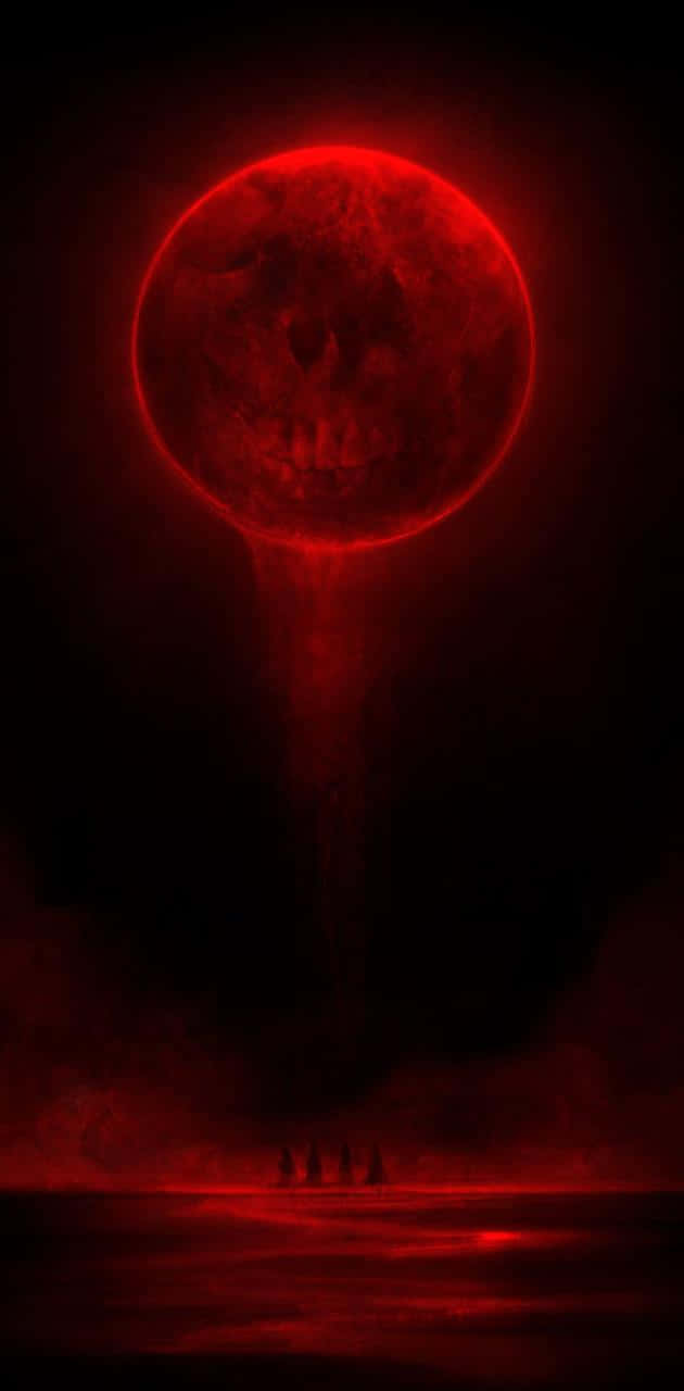 Red Moon 桌布 壁紙 — 一個血紅色的骷髏月亮籠罩在黑暗的景觀上，小小的身影在其不祥的光芒下敬畏地站立。