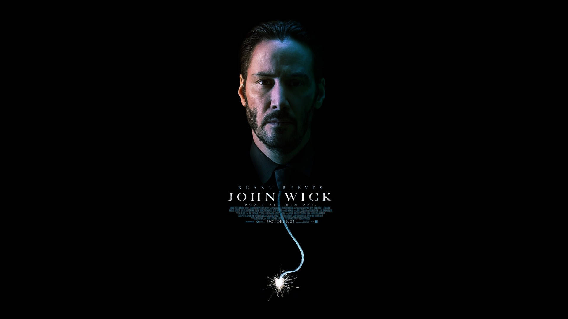 John Wick 桌布 壁紙 — 一個表情嚴肅的男人，下巴下方懸掛著點燃的導火索，背景為黑色。