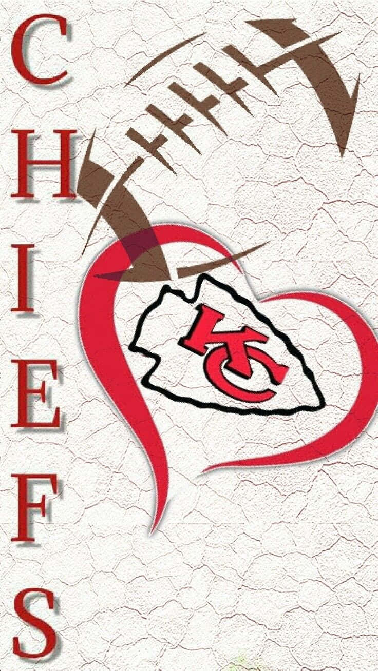 Kansas City Chiefs Logo 桌布 壁紙 — 一個裂開的白色背景上有一個紅色心形輪廓，內含堪薩斯城酋長隊標誌，上方有一個棕色的足球呈弧形。