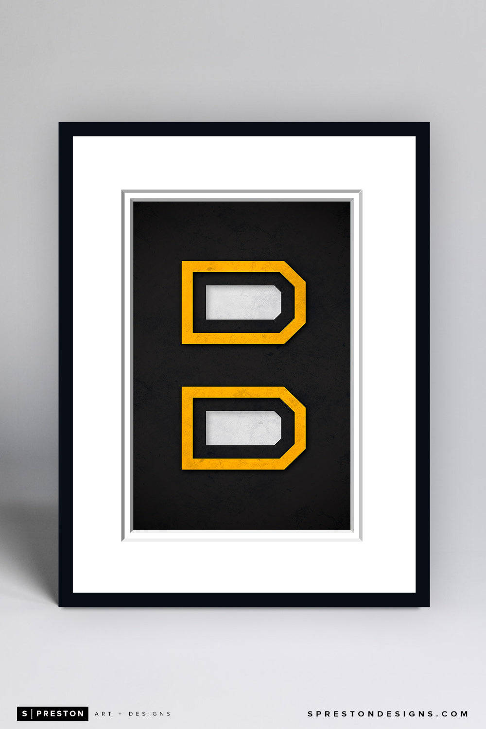 Frame 桌布 壁紙 — 一個裱框的極簡藝術作品，在黑色紋理背景上展示兩個堆疊的黃色輪廓D，配有白色襯紙。