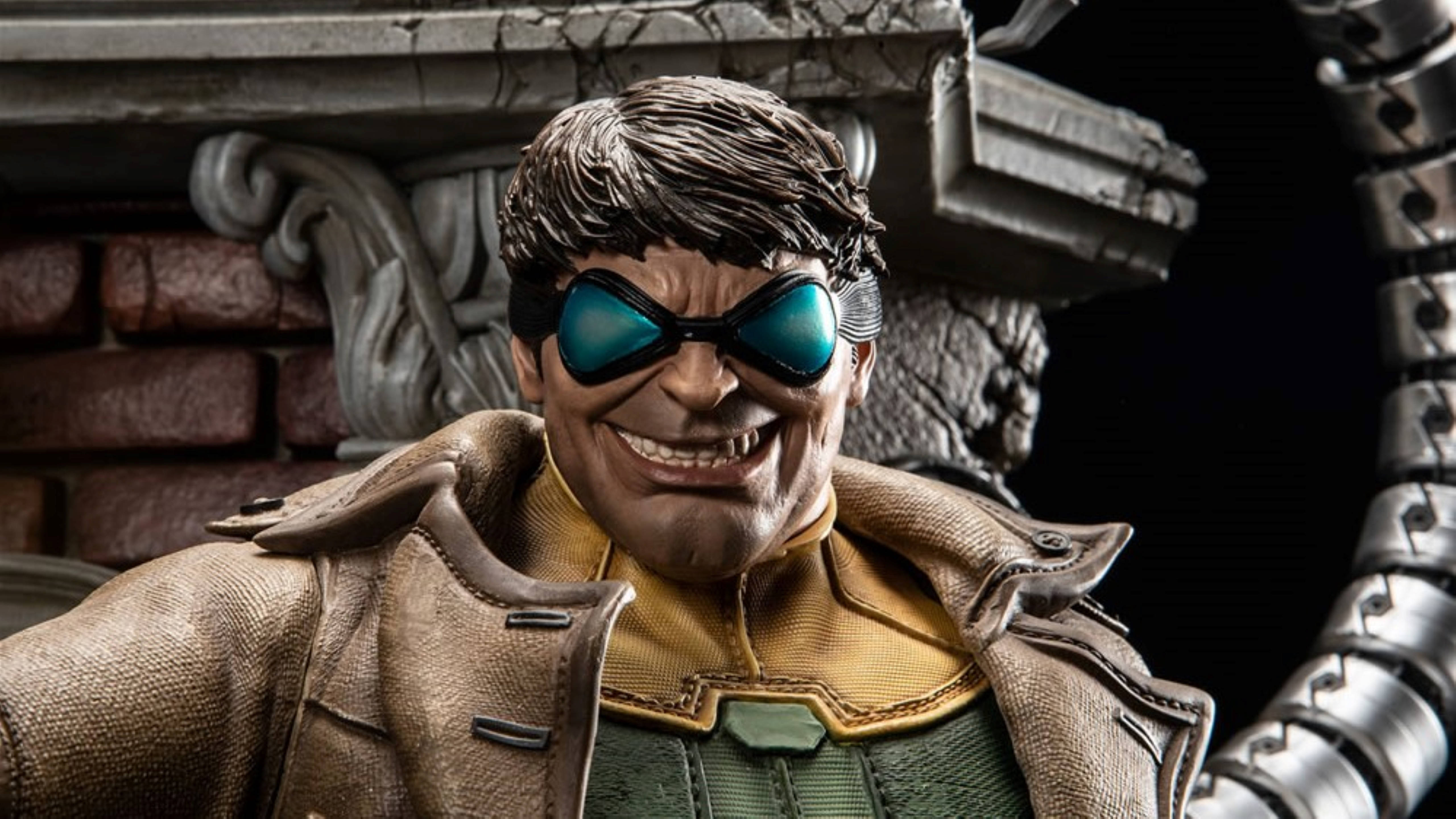Doctor Octopus 桌布 壁紙 — 一個詳細的雕像，一個微笑的男人穿著棕色外套和藍色護目鏡，站在一個機械臂旁邊，背景是磚石。
