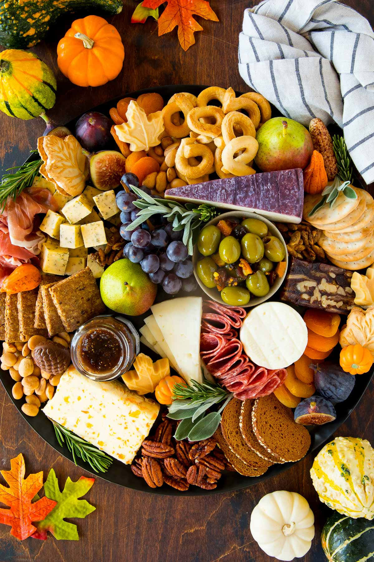 Fall Thanksgiving 桌布 壁紙 — 一個豐盛的秋季熟食拼盤，在質樸的木桌上擺滿了起司、肉類、水果、堅果和葫蘆。