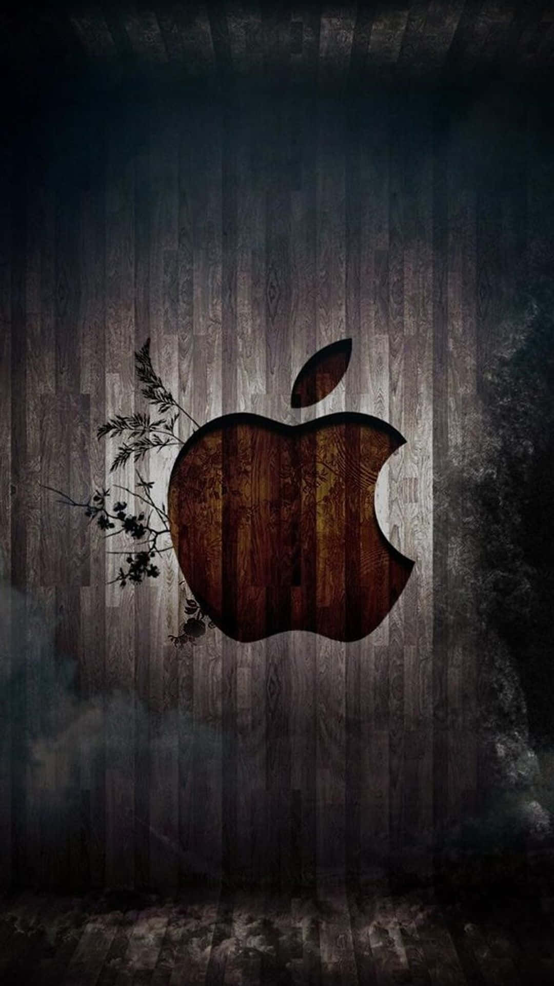 iPhone X Apple Logo 桌布 壁紙 — 一個質樸的木製Apple標誌，帶有深色樹葉點綴，背景是風化的垂直木板。