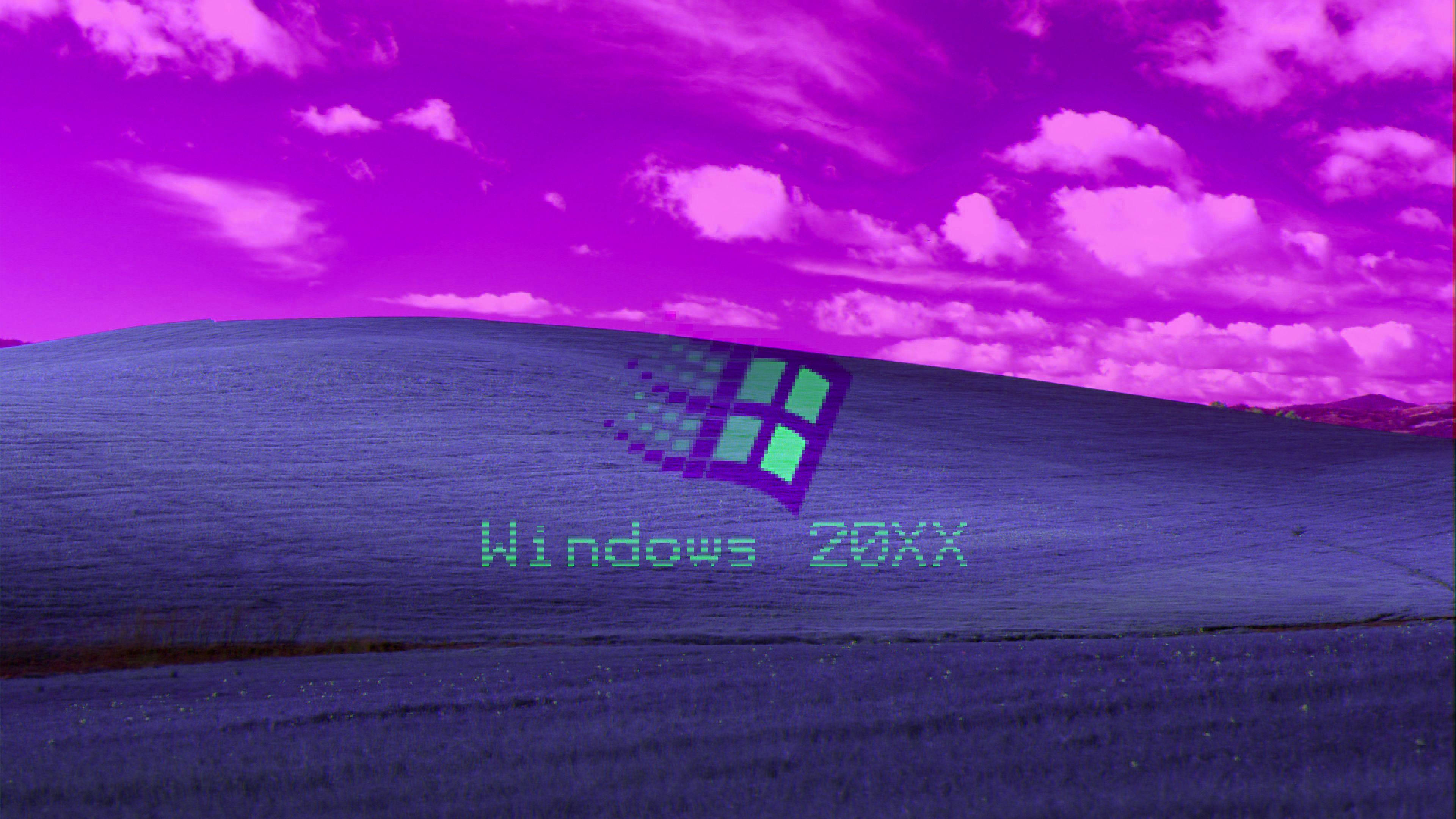 Windows 98 桌布 壁紙 — 一個超現實的紫色景觀，在充滿活力的洋紅色天空下有一個起伏的山丘，帶有像素化的Windows標誌和文字。