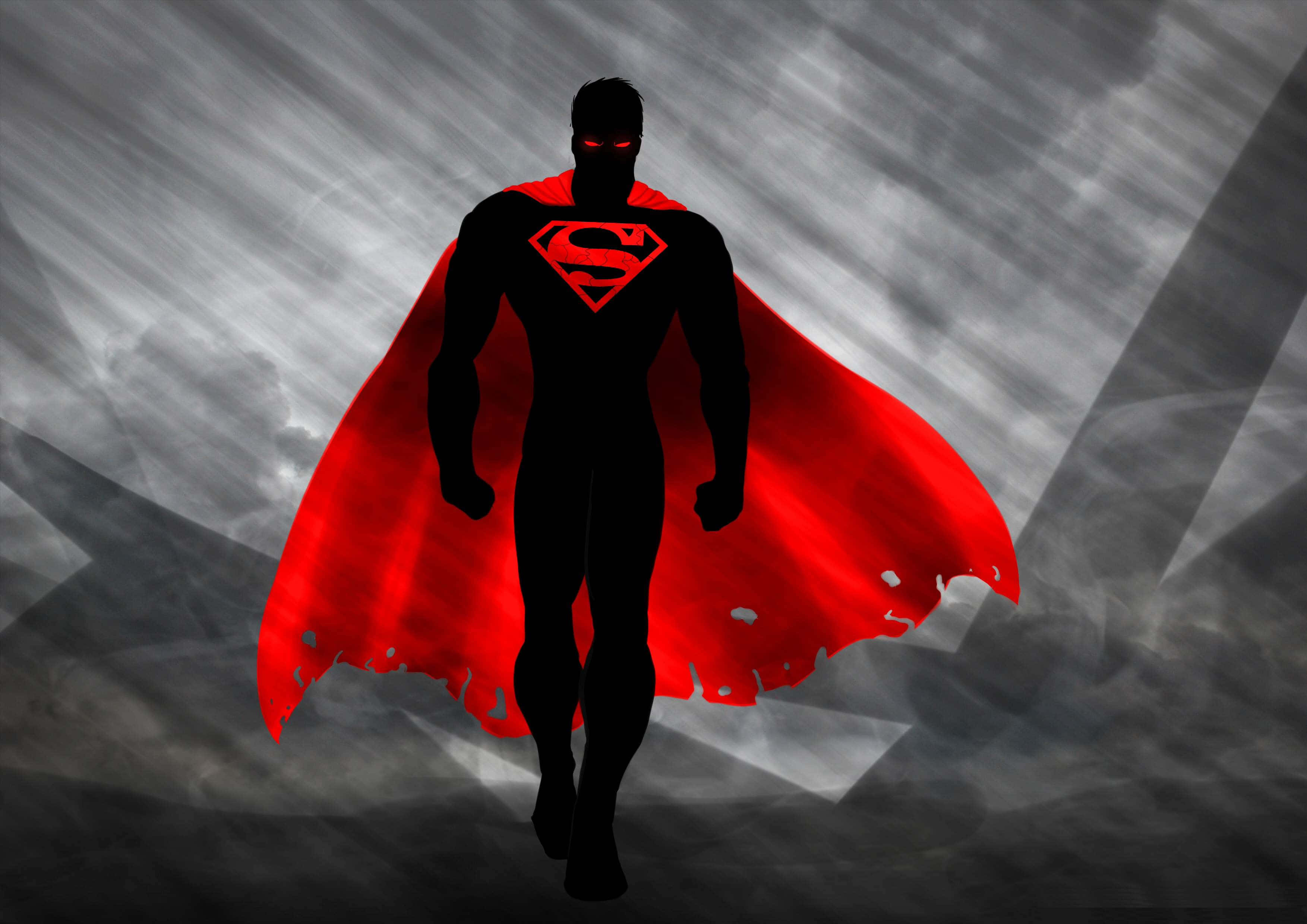 Animated Superhero Movies 桌布 壁紙 — 一個超級英雄剪影，擁有發光的紅色眼睛和飄逸的紅色斗篷，站在暴風雨的灰色天空前。