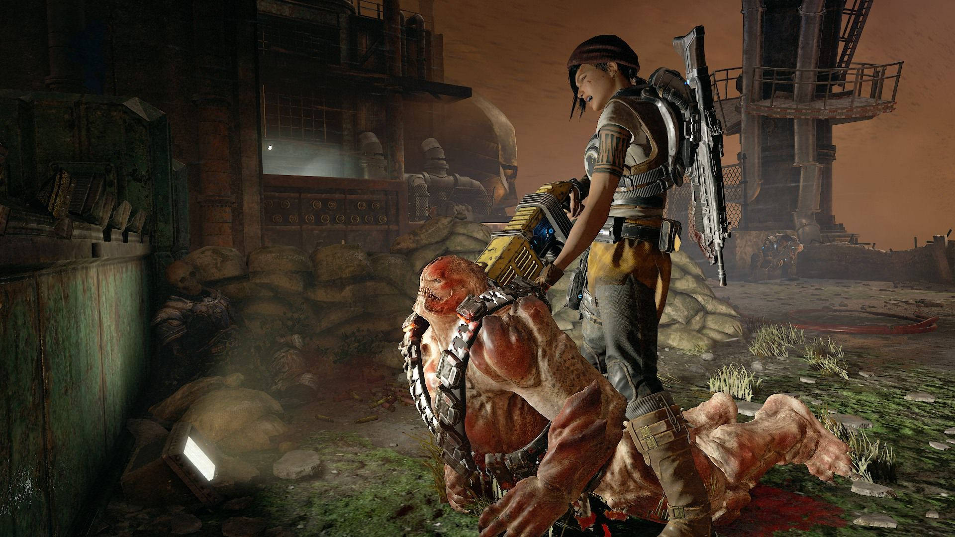 Gears 5 桌布 壁紙 — 一個身穿盔甲的戰士站在一個被擊敗的怪物之上，背景是破敗的工業環境。