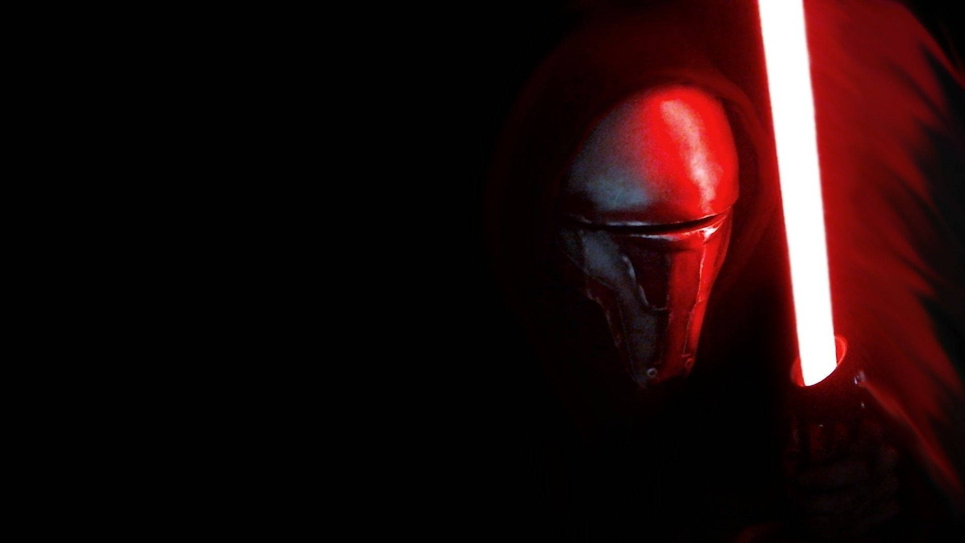 Revan 桌布 壁紙 — 一個身穿紅色連帽斗篷的可怕人物，在漆黑的背景下揮舞著發光的紅色光劍。