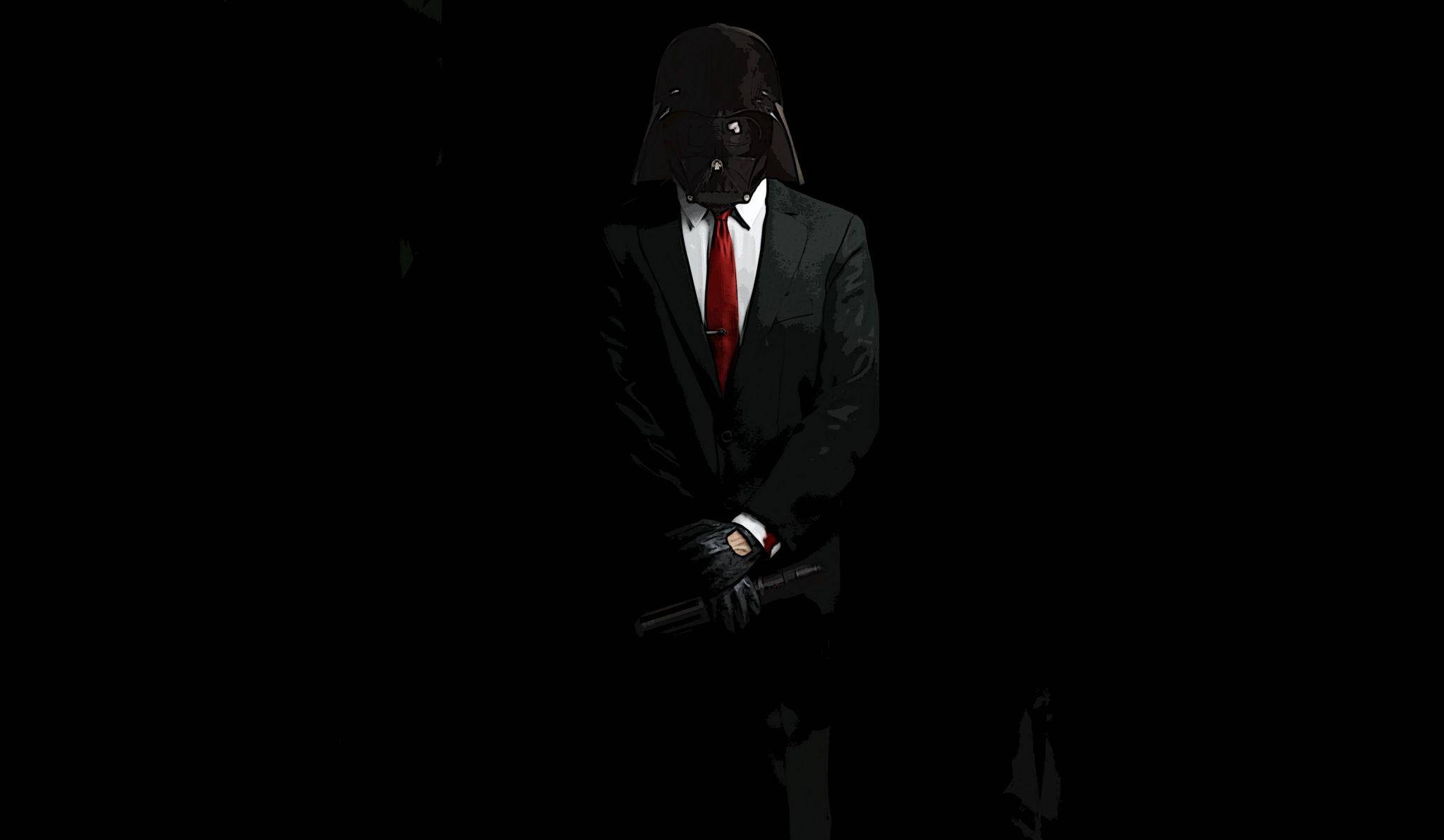 Mafia 桌布 壁紙 — 一個身穿黑武士頭盔和西裝、打著紅色領帶的黑色身影，在黑色背景襯托下呈現剪影，手持爆能槍。