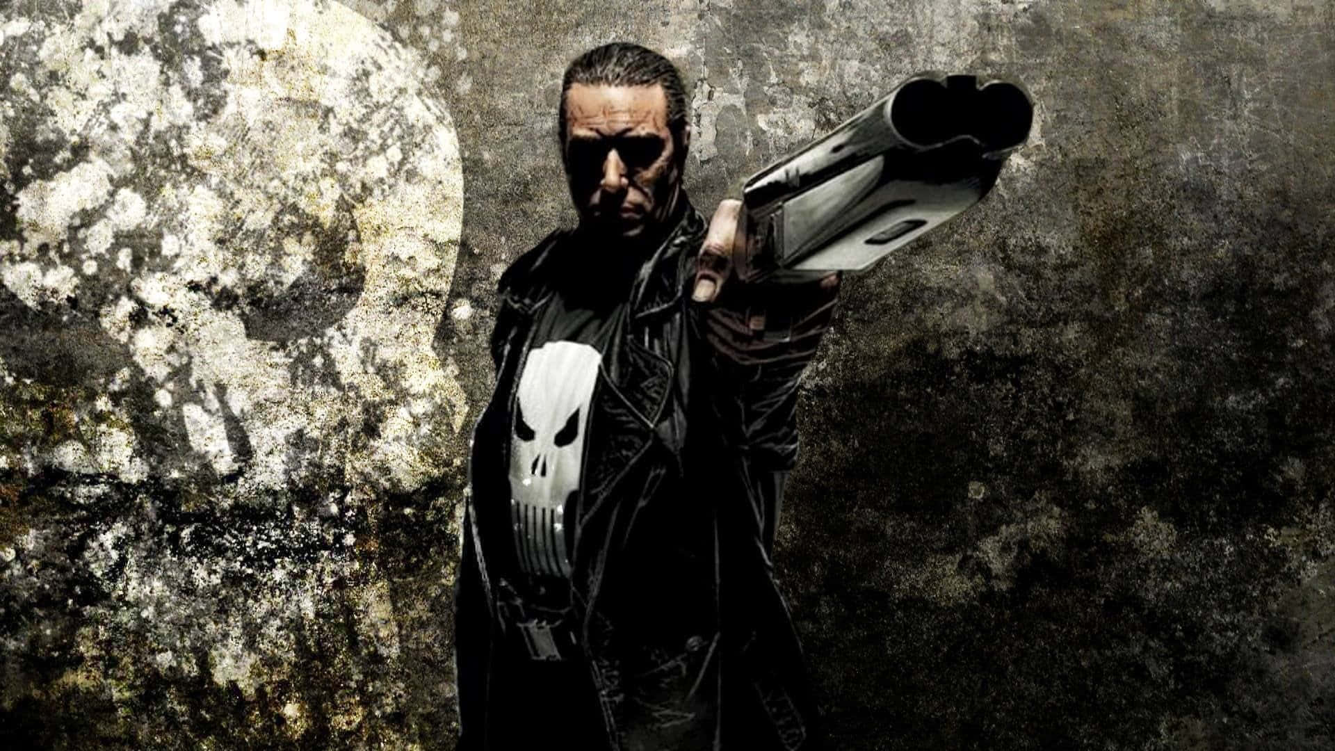 Punisher Desktop 桌布 壁紙 — 一個身穿黑色風衣、帶有骷髏標誌的粗獷義警，用霰彈槍瞄準一面風化的牆壁。