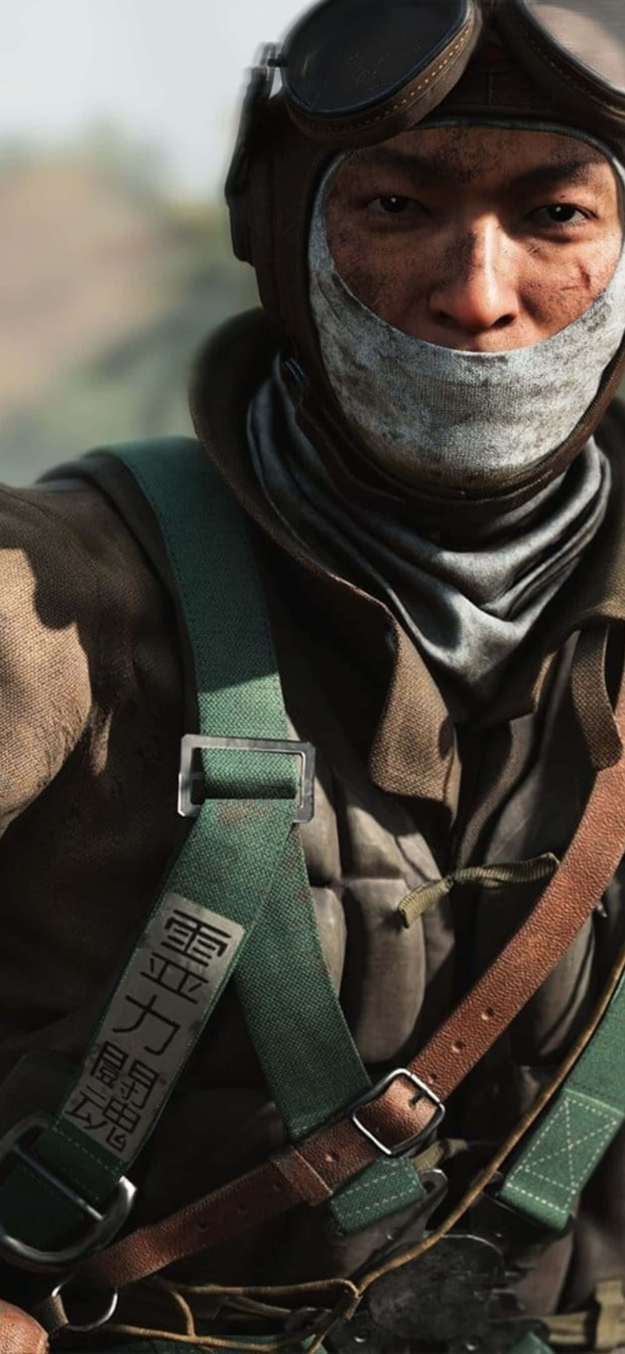 HD Battlefield V 桌布 壁紙 — 一個近距離鏡頭，展示一位戴著護目鏡和圍巾的堅毅戰鬥機飛行員，正凝視著觀眾。