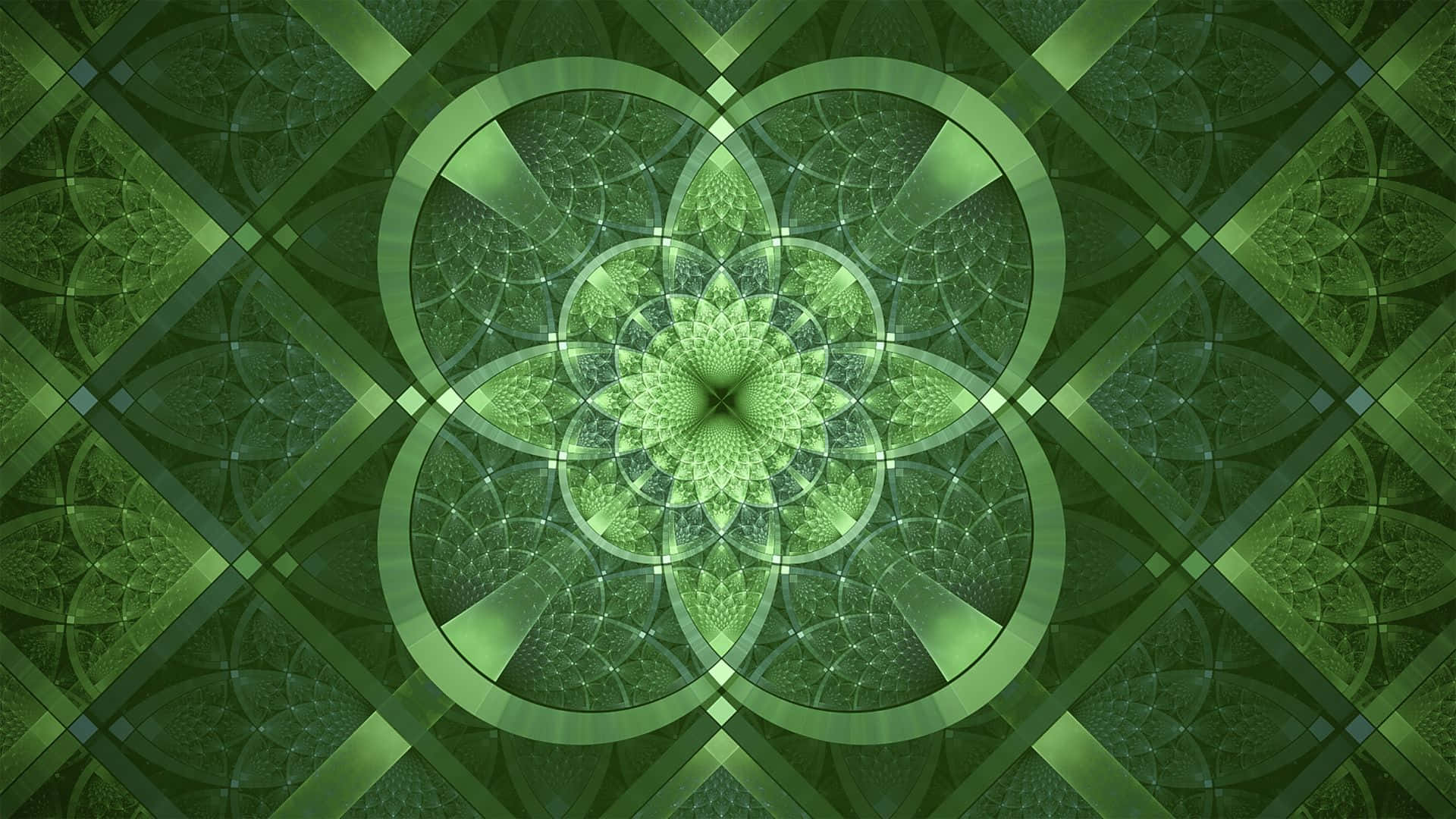 碎形 桌布 壁紙 — 一個迷人的綠色碎形曼陀羅，具有從中央花狀核心輻射出的對稱幾何圖案。