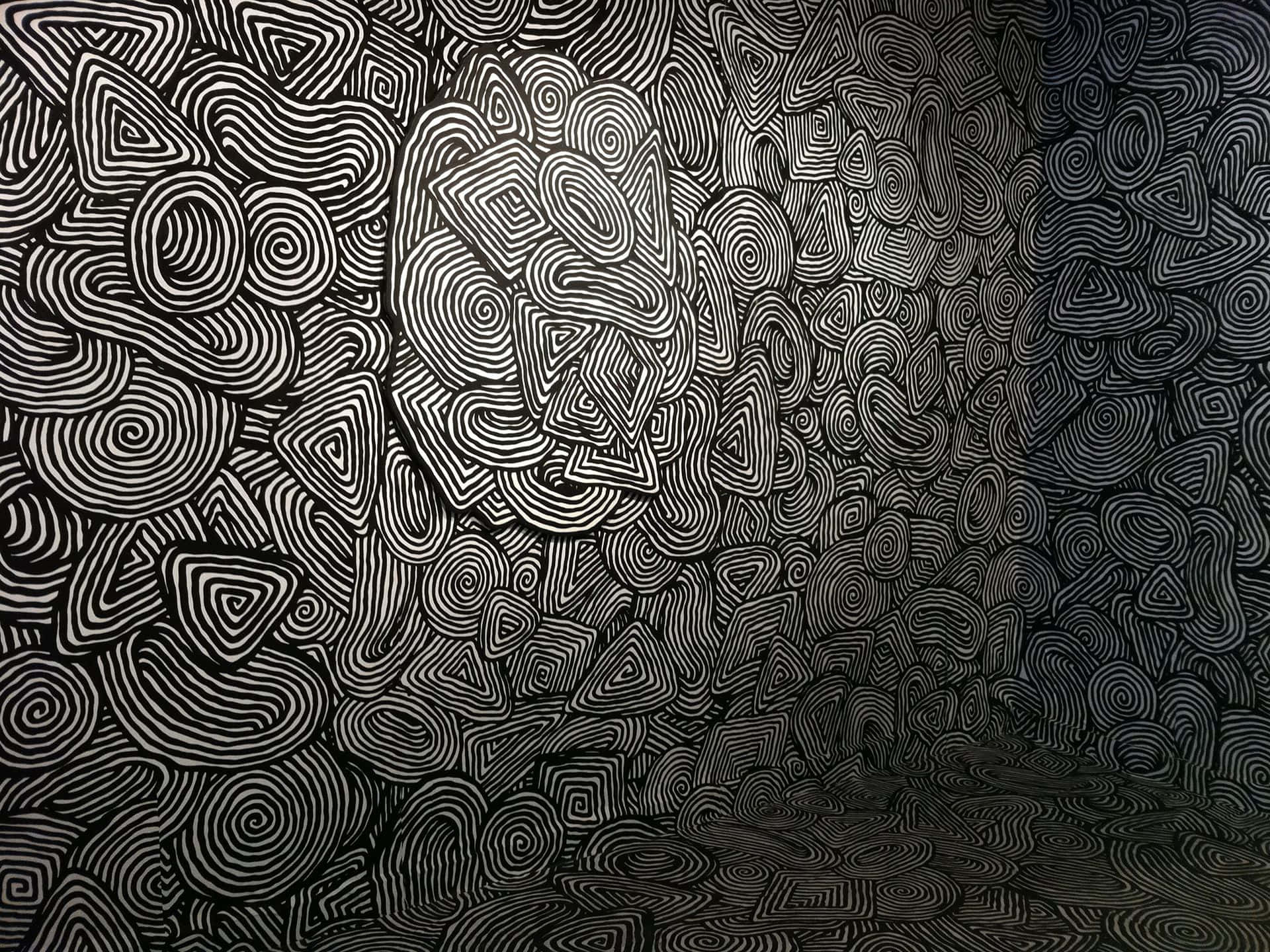 Black And White Pattern 桌布 壁紙 — 一個迷人的黑白抽象圖案，由漩渦線條和嵌套三角形組成，營造出催眠般的視覺節奏。