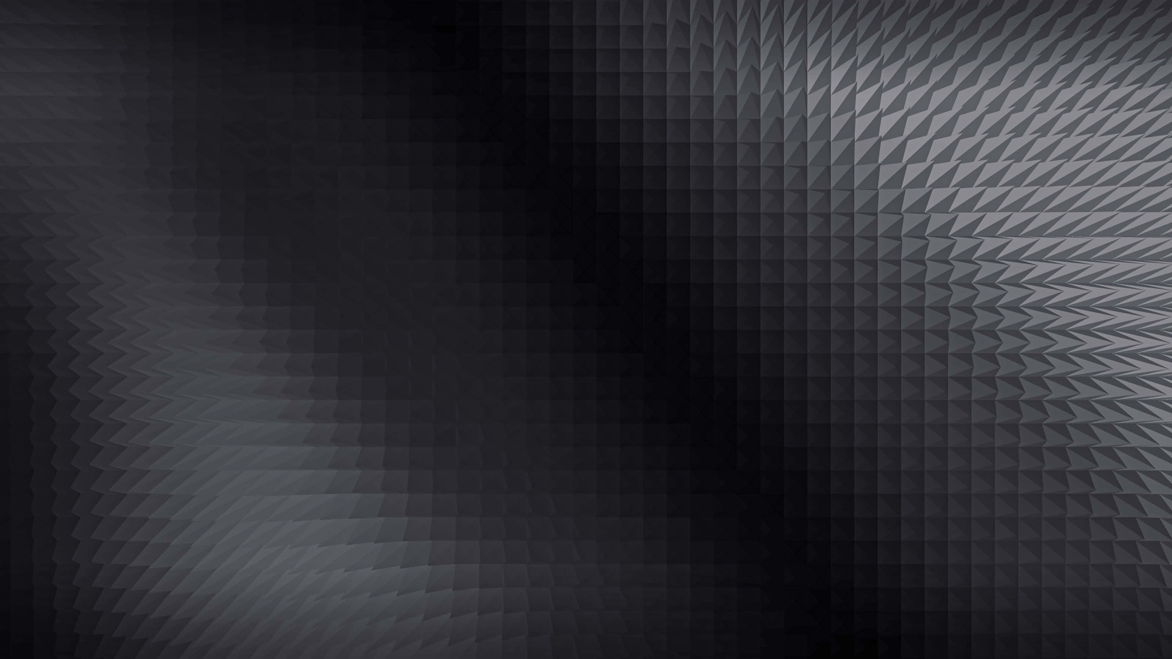 Black Gradient 桌布 壁紙 — 一個重複幾何三角形的深色抽象圖案，從黑色漸變到灰色，帶有微妙的漸變效果。