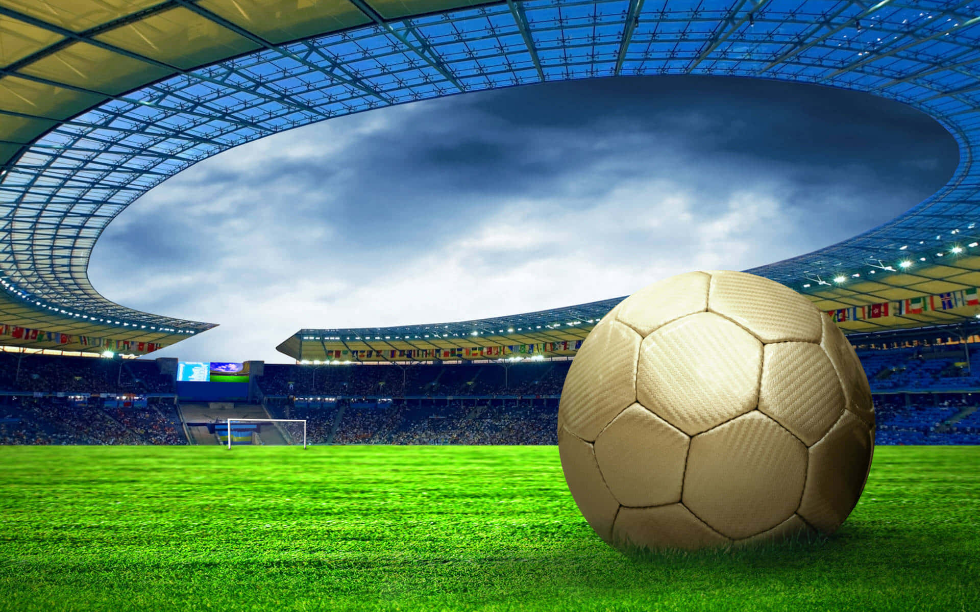 Football Field 桌布 壁紙 — 一個金色足球放在一個巨大現代體育場的鮮綠色草地上，天空佈滿戲劇性的雲層。