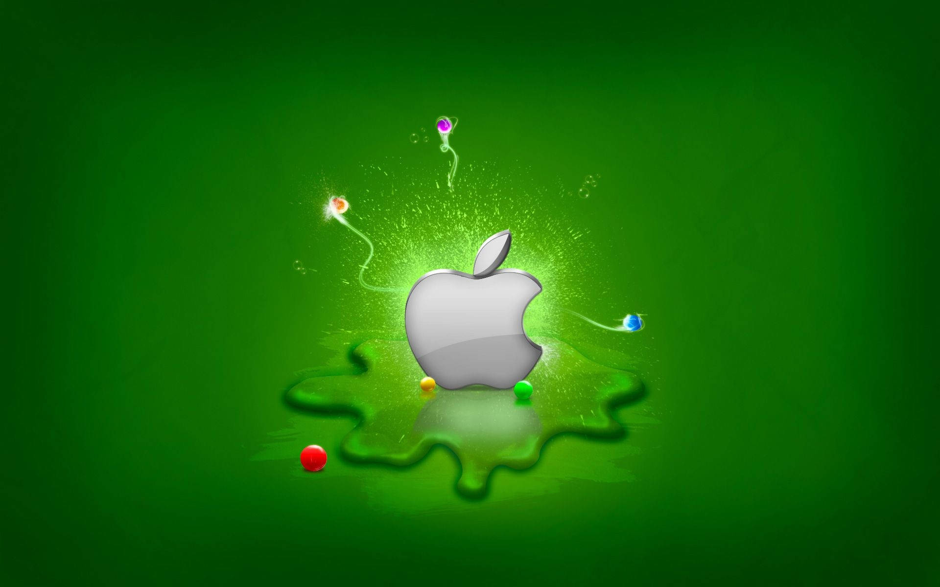 Mac Os 桌布 壁紙 — 一個銀色Apple標誌從發光的綠色水坑中浮現，周圍有彩色粒子旋轉。