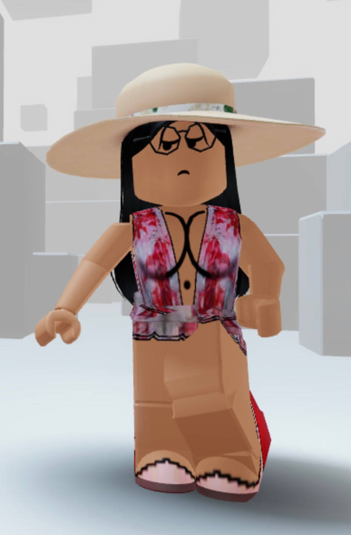 美學 Roblox 女孩 桌布 壁紙 — 一個長黑髮的Roblox虛擬角色戴著寬邊帽、眼鏡和紅色花卉上衣，站在簡約的灰色方塊環境中。