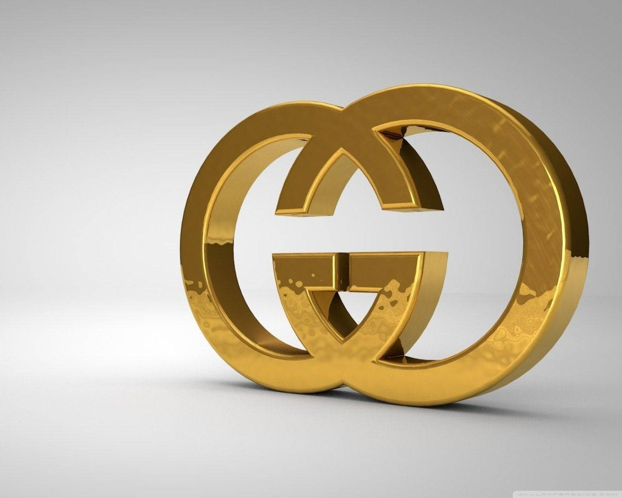 Gucci 桌布 壁紙 — 一個閃亮的金色互鎖G標誌居中放置在柔和的漸變灰色背景上，帶有微妙的反射。