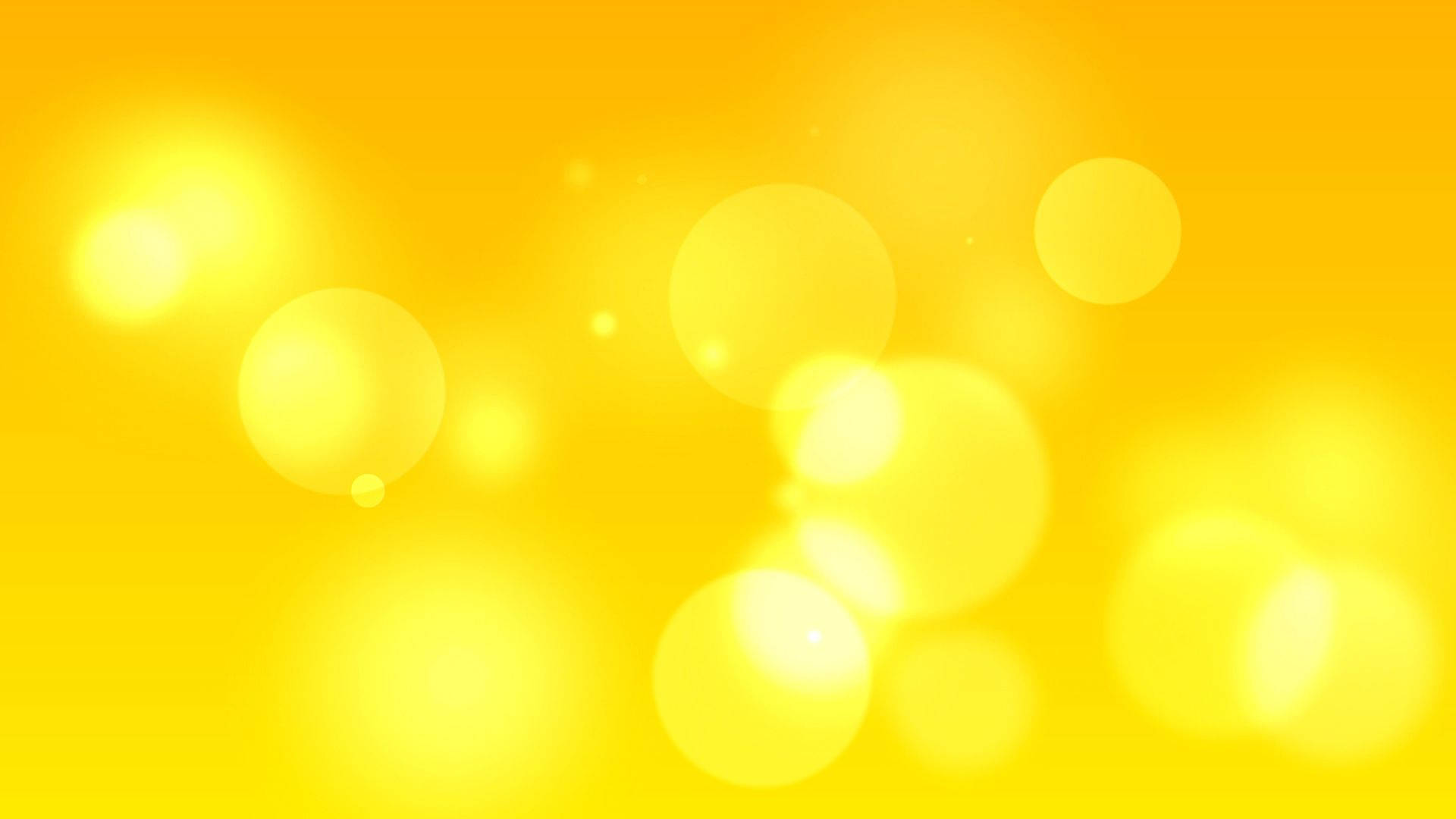 Bokeh 桌布 壁紙 — 一個閃耀的金色背景，充滿柔和發光的散景圓圈，營造出溫暖夢幻的氛圍。