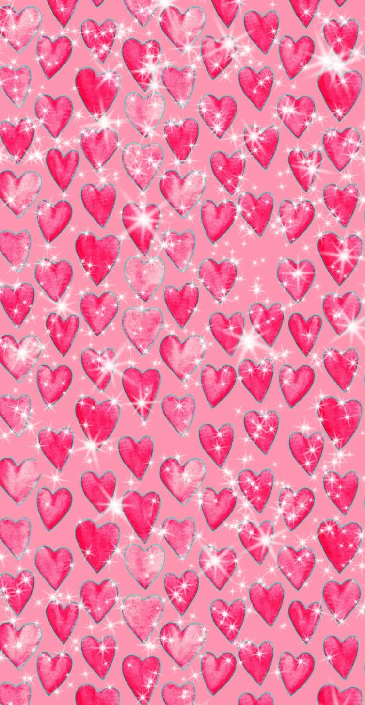 Cute Valentines 桌布 壁紙 — 一個閃閃發光的粉紅色桌布，充滿了不同色調的閃亮心形，營造出節日浪漫的圖案。