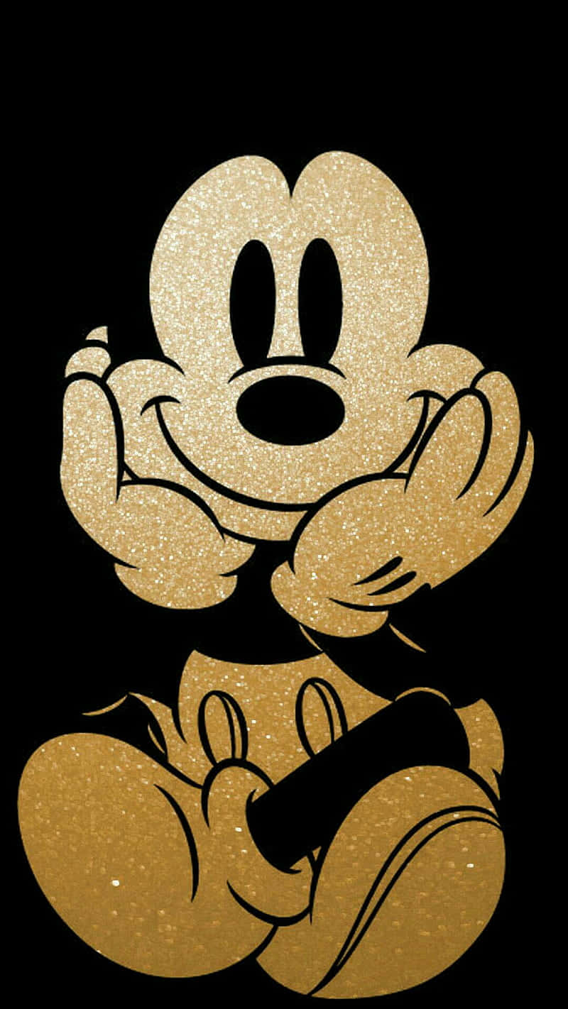 Mickey Mouse Cool 桌布 壁紙 — 一個閃閃發光的金色米奇老鼠剪影在純黑色背景上愉快地微笑。