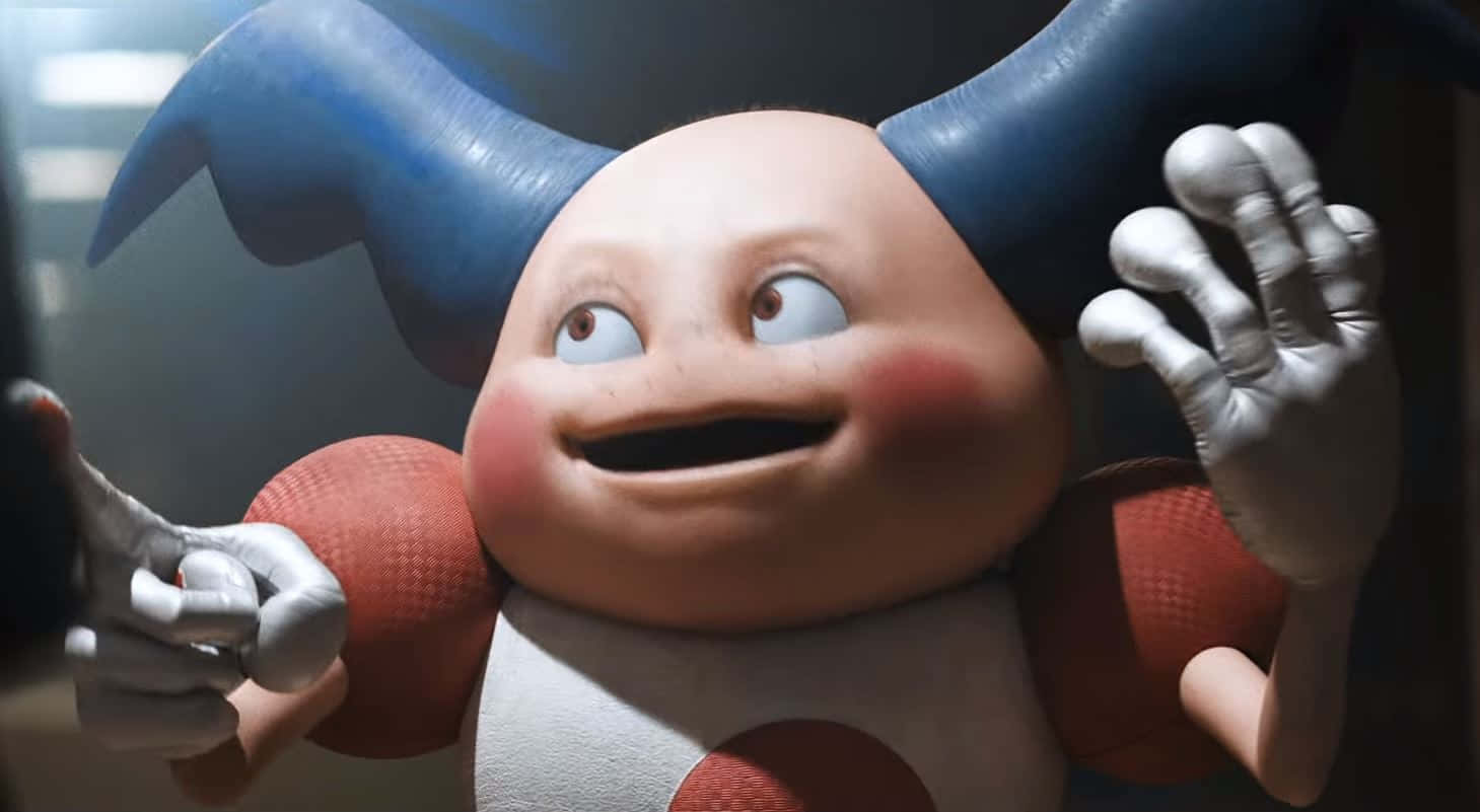 Mr. Mime 桌布 壁紙 — 一個開心的卡通角色，有藍色角和紅色手臂，睜大眼睛、臉頰紅潤，愉快地揮手。