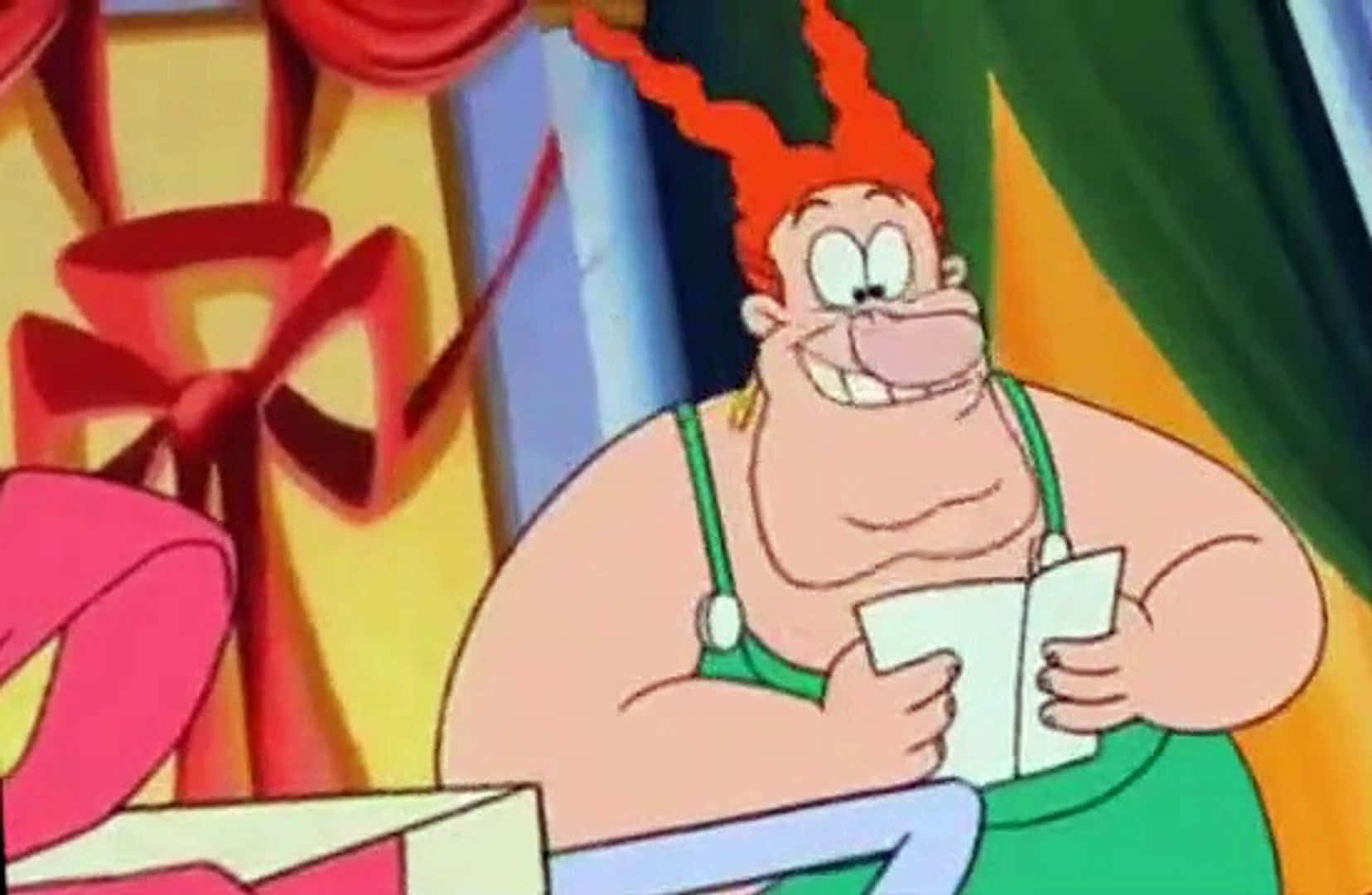 The Wacky World Of Tex Avery 桌布 壁紙 — 一個開心的卡通角色，紅頭髮、綠色吊帶褲，在色彩繽紛的禮物包裝中拿著一張便條。