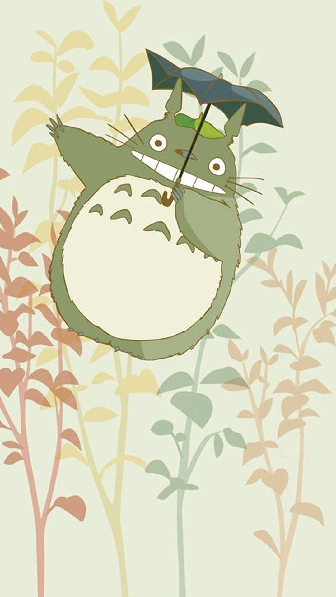 Studio Ghibli iPhone 桌布 壁紙 — 一個開心的綠色龍貓角色在柔和的粉彩樹葉中拿著一把黑色雨傘，構成一個奇妙的動畫場景。